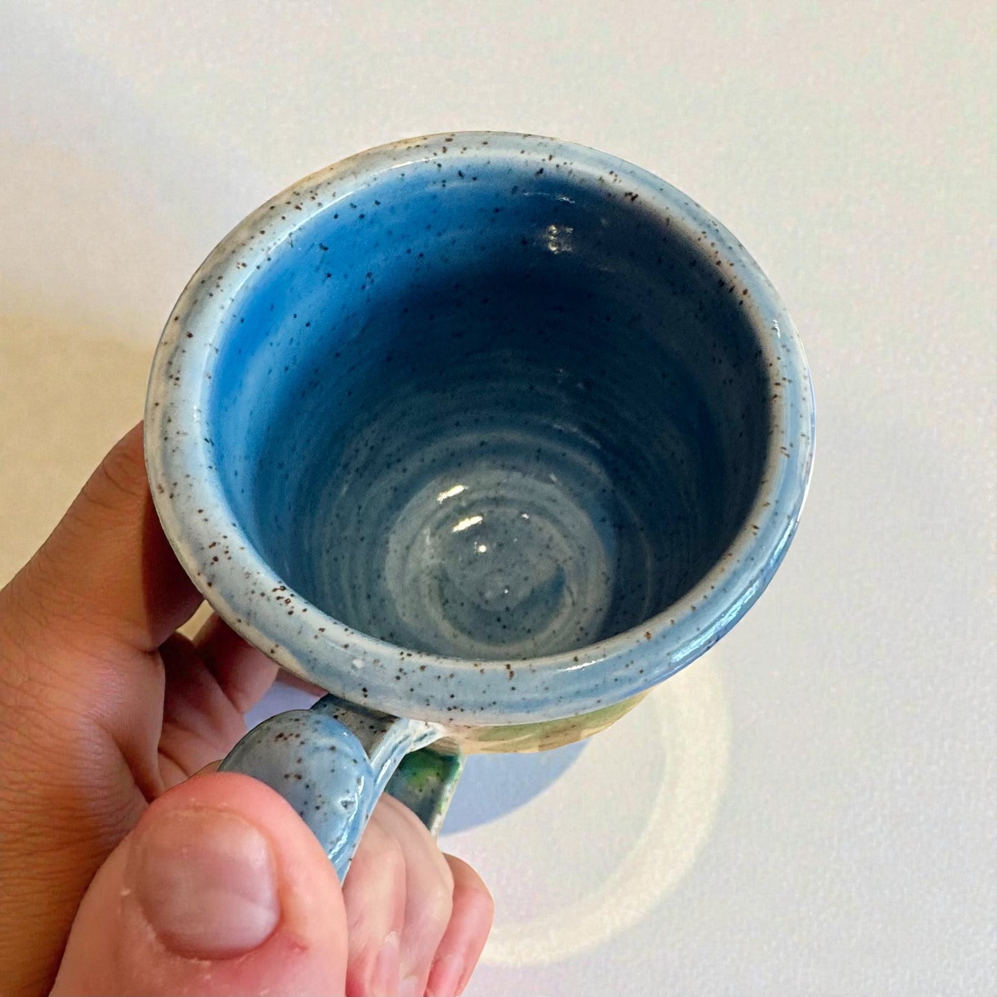 Rock N Art Shop Forest Bear stoneware mug with raised silhouette and blue speckled glaze. 12 oz handmade ceramic drinkware.