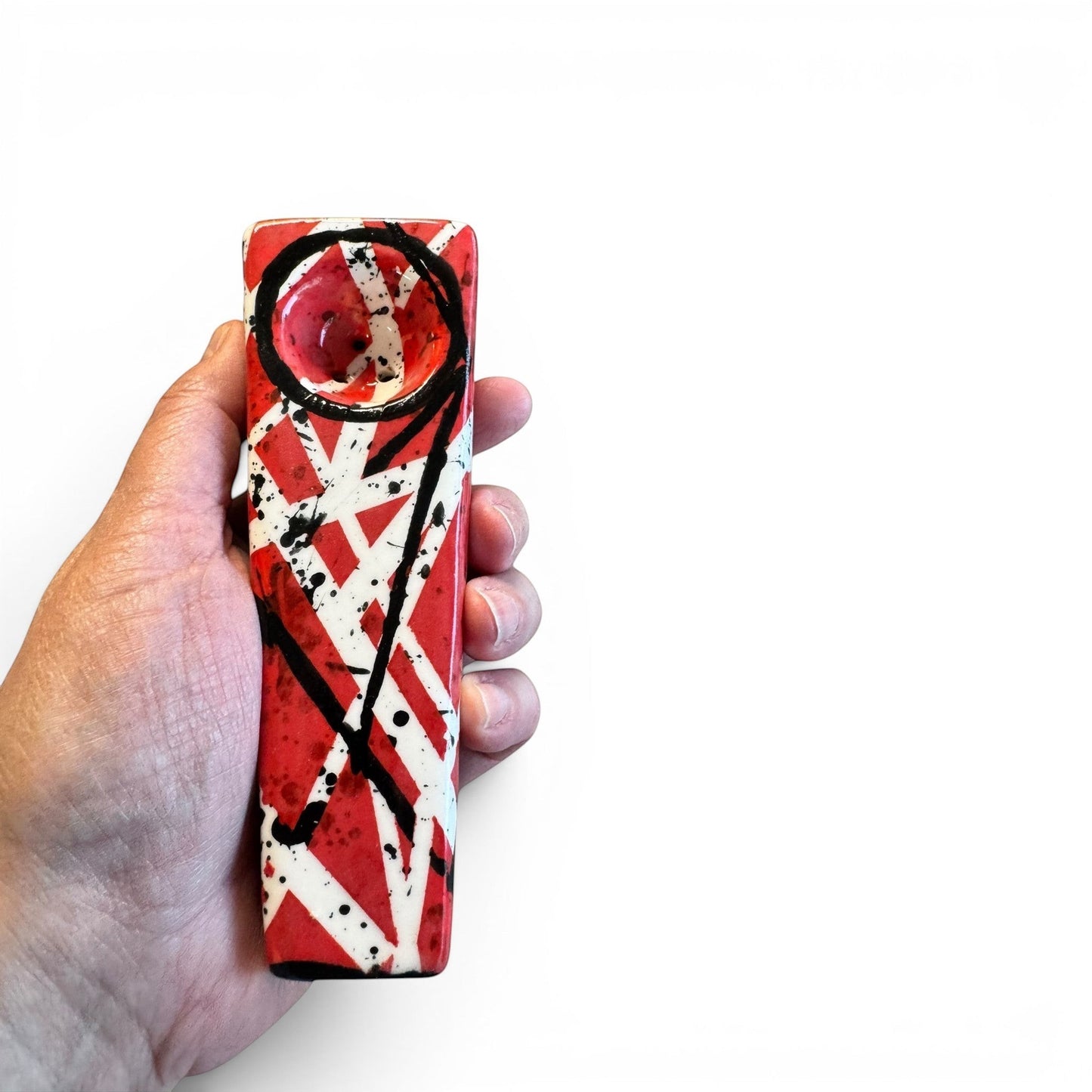 Rock N Art Shop hand-decorated stoneware tobacco pipe with red, black, and white diagonal stripe design and black splatter accents.