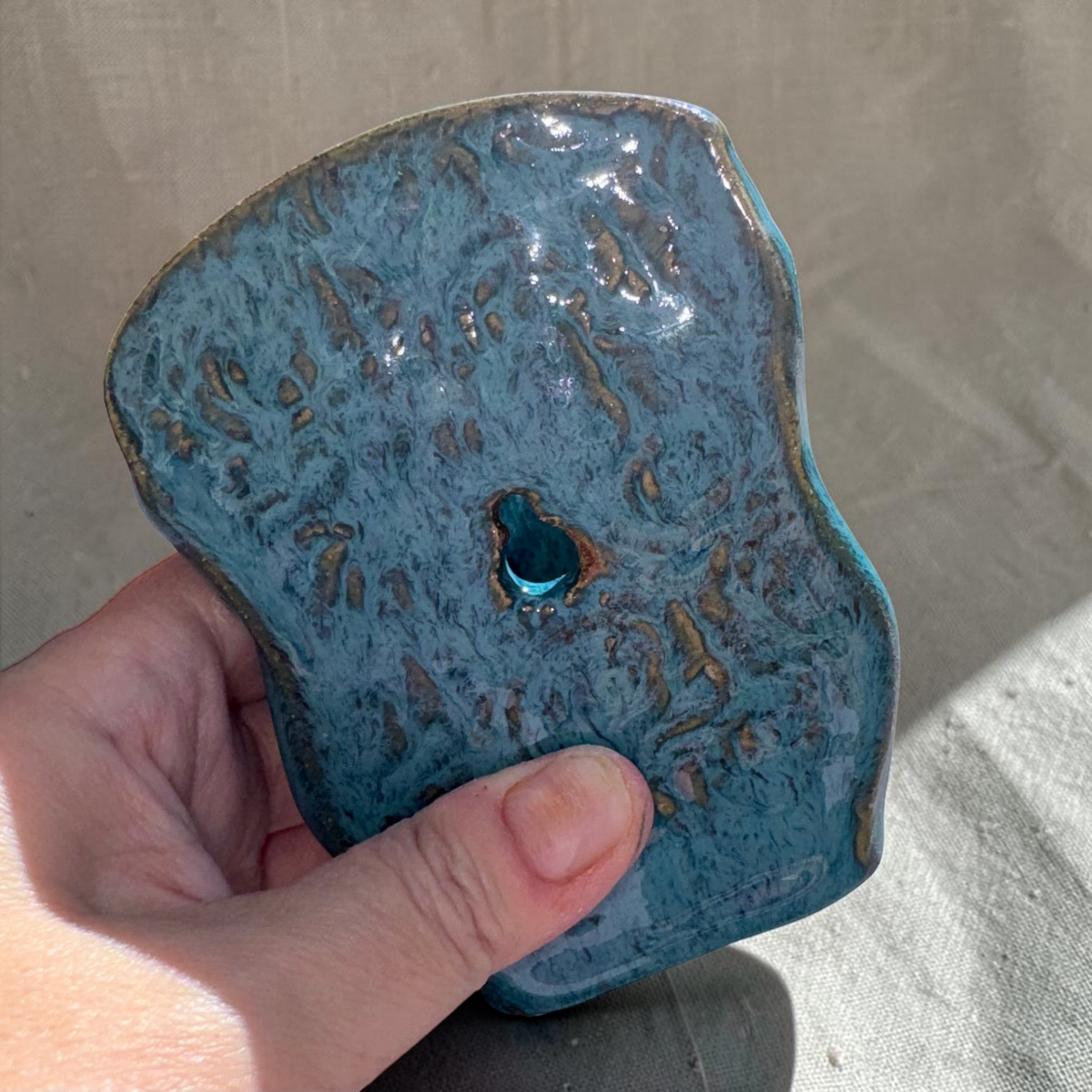 Rock N Art Shop turquoise and blue speckled stoneware wall pocket vase with textured backplate and hanging hole.