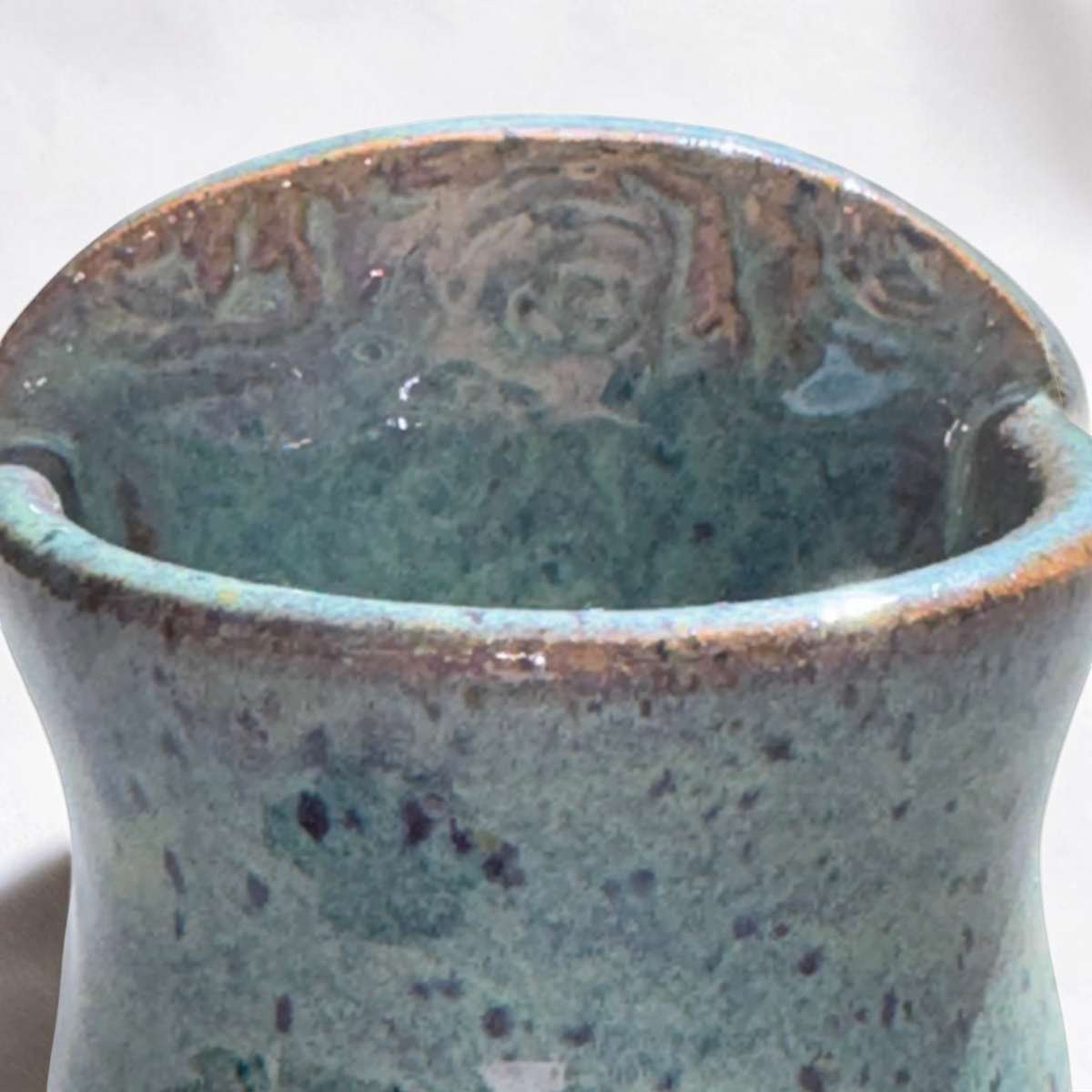 Rock N Art Shop handmade speckled stoneware wall pocket vase in a blue-green glaze with textured impressed details.