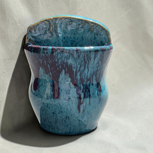 Rock N Art Shop handmade speckled stoneware wall pocket vase in turquoise and blue with plum-brown glaze drips.