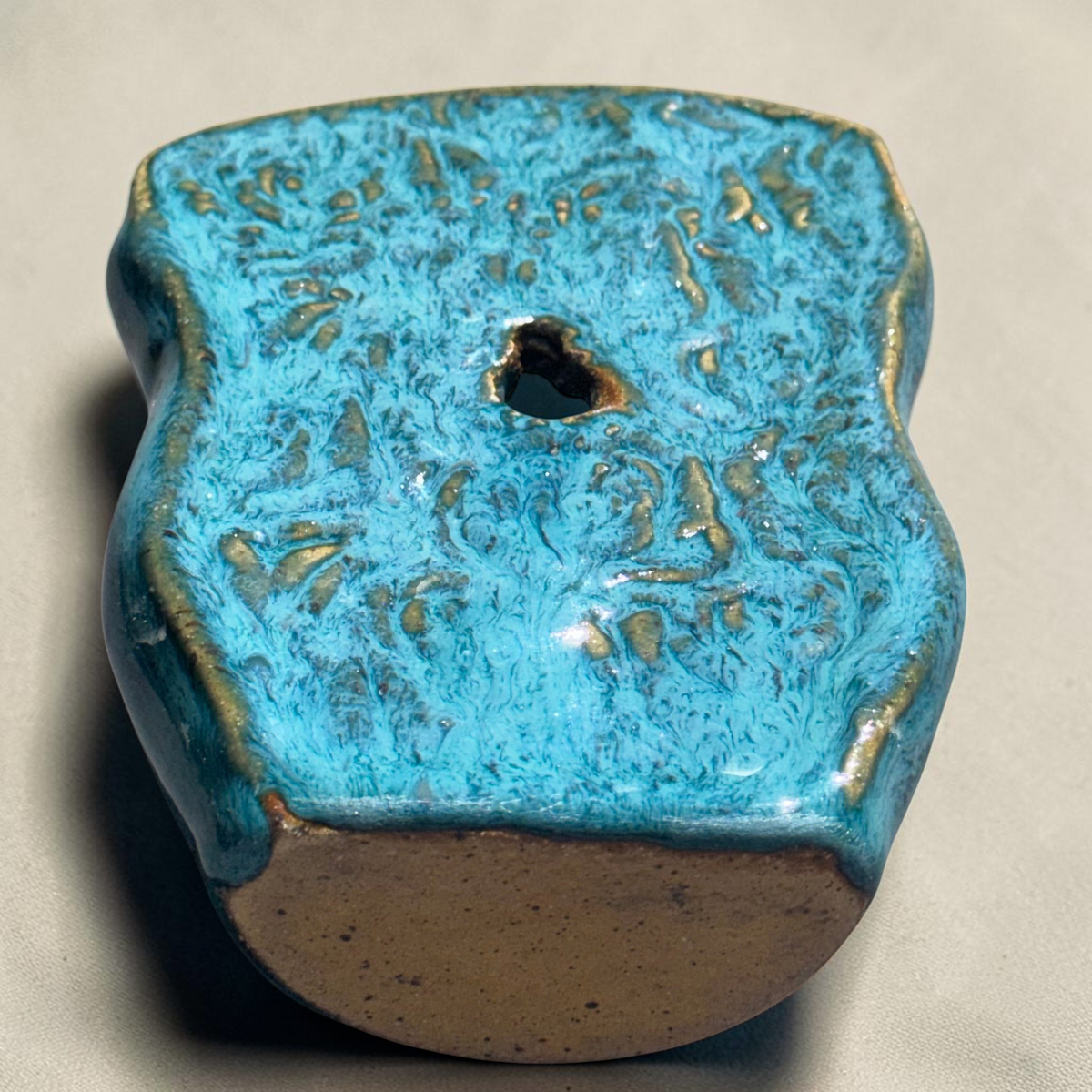 Rock N Art Shop turquoise and blue speckled stoneware wall pocket vase with textured backplate and hanging hole.