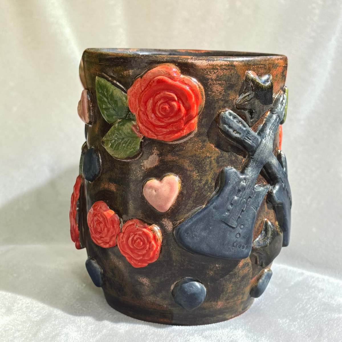 Rock N Art Shop handmade stoneware mug with red roses, pink hearts, and electric guitar ceramic embellishments.