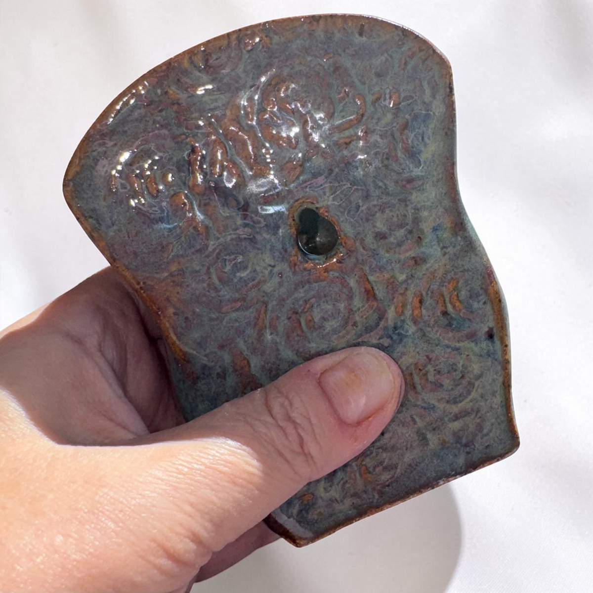 Rock N Art Shop handmade speckled stoneware wall pocket vase with a textured blue-green glaze and hanging hole.