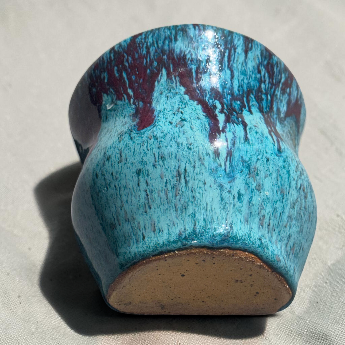 Rock N Art Shop handmade speckled stoneware wall pocket vase in turquoise and blue with plum-brown glaze drips.