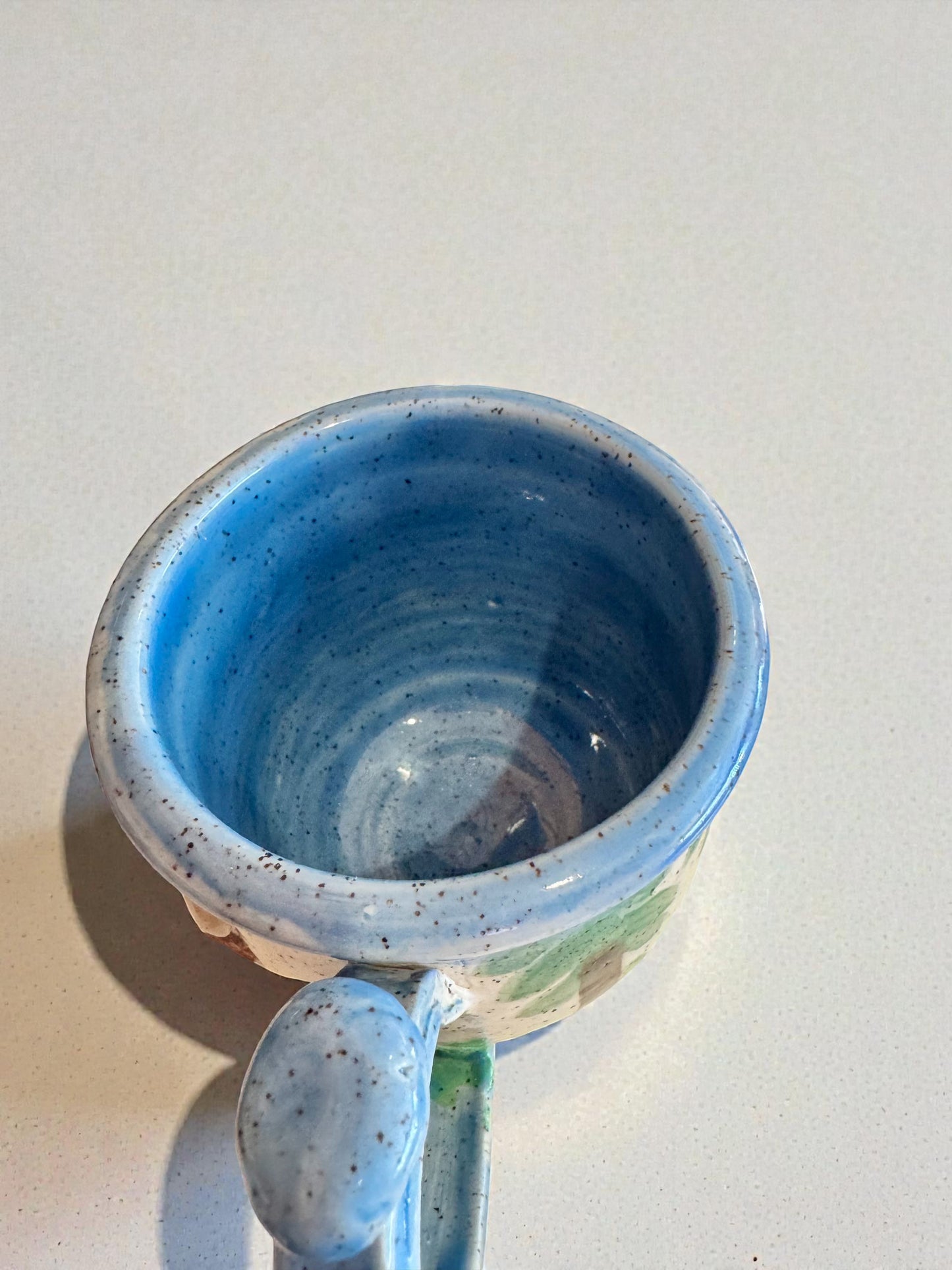 Rock N Art Shop Forest Bear stoneware mug with raised silhouette and blue speckled glaze. 12 oz.