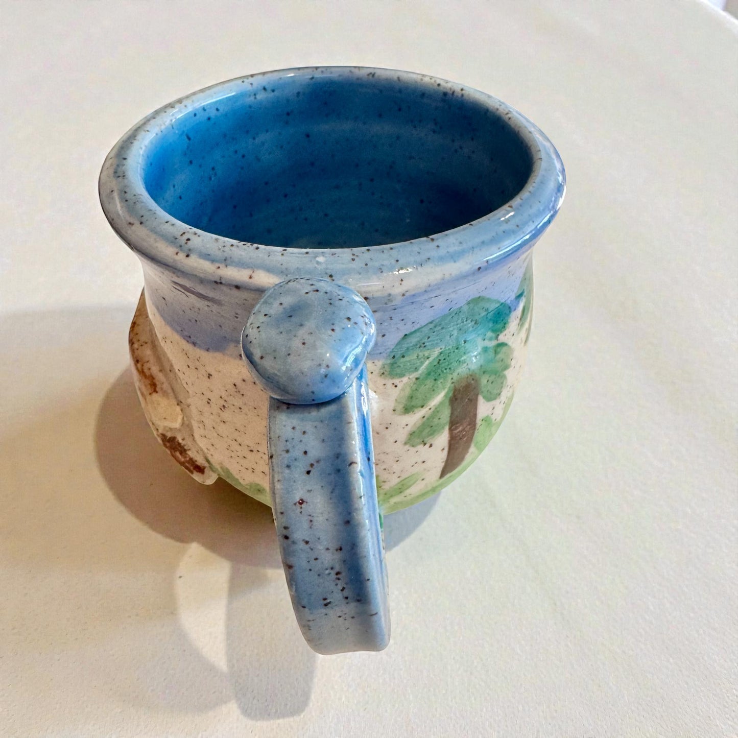 Rock N Art Shop Forest Bear stoneware mug with raised silhouette and hand-glazed forest scene in cabin tones. Approx. 12 oz.