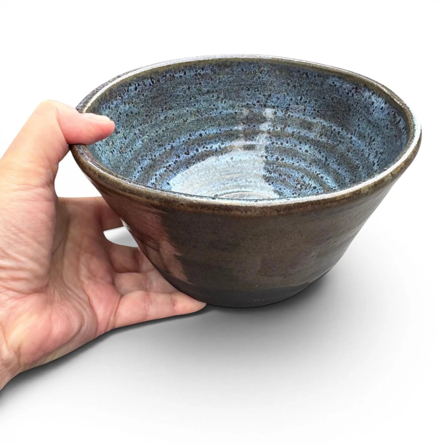 Rock N Art Shop large black clay stoneware bowl with stormy blue interior and copper-rust exterior glaze.