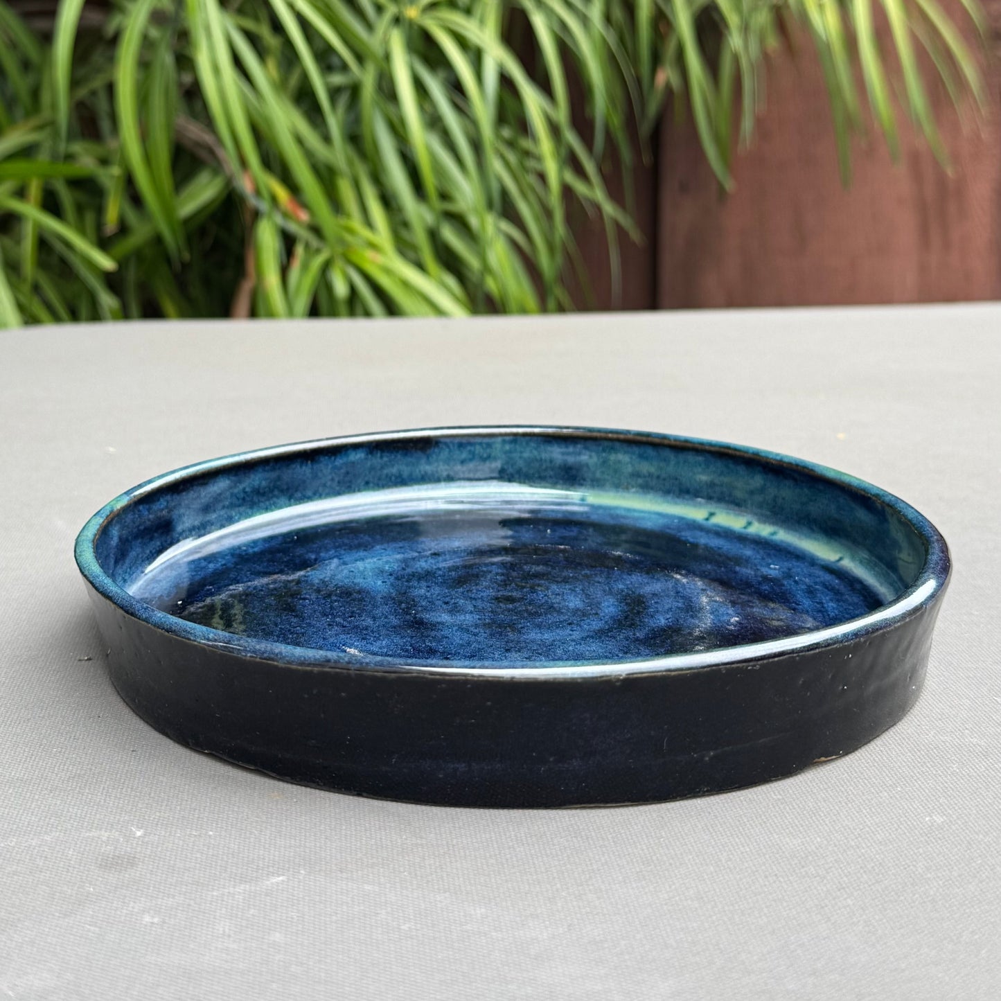 Rock N Art Shop handmade blue and turquoise stoneware saucer for a berry bowl with a glossy ocean wave glaze finish.