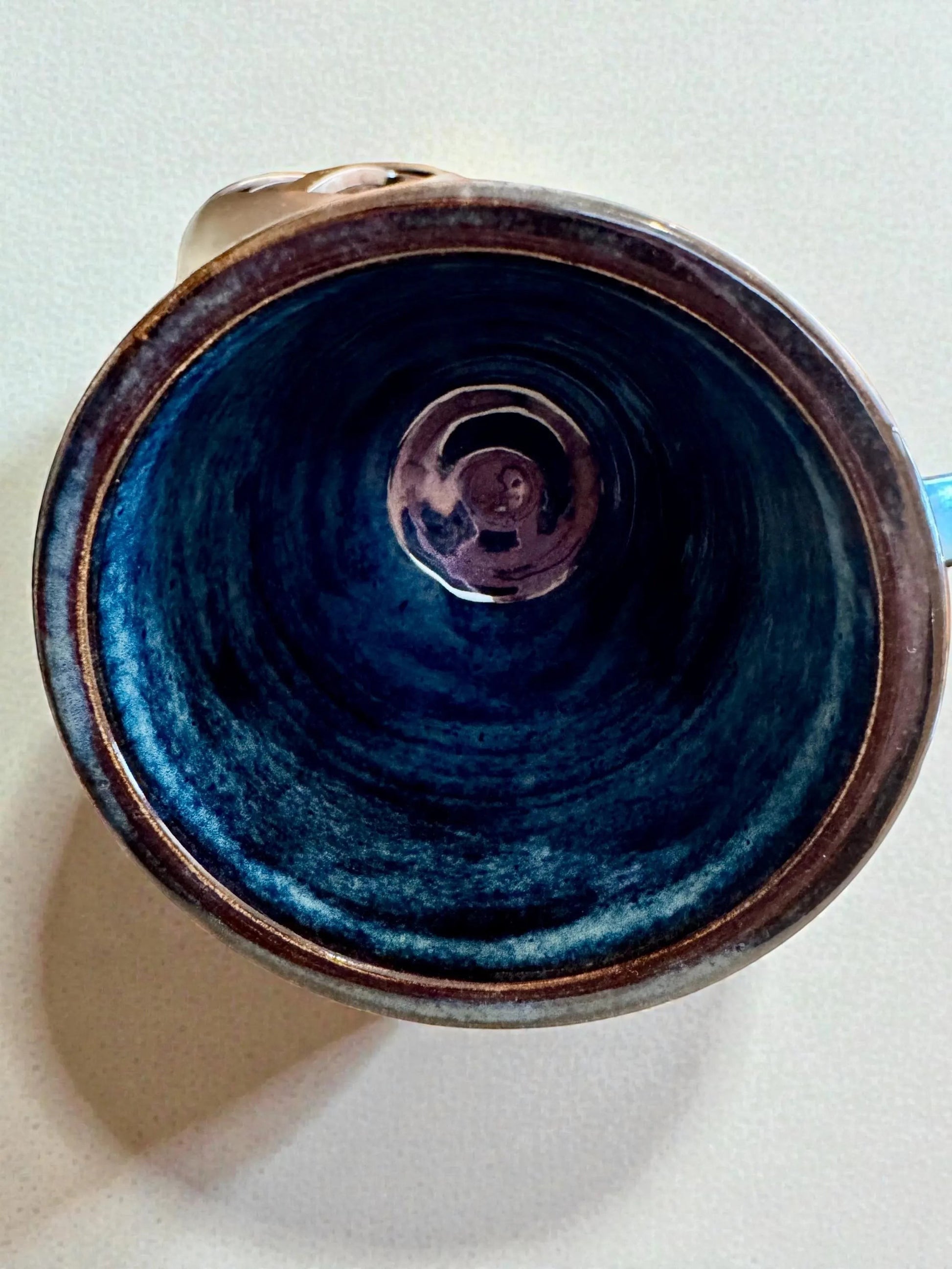 Rock N Art Shop handmade blue stoneware tumbler, 12 oz wheel-thrown pottery with layered blue glaze and subtle texture.