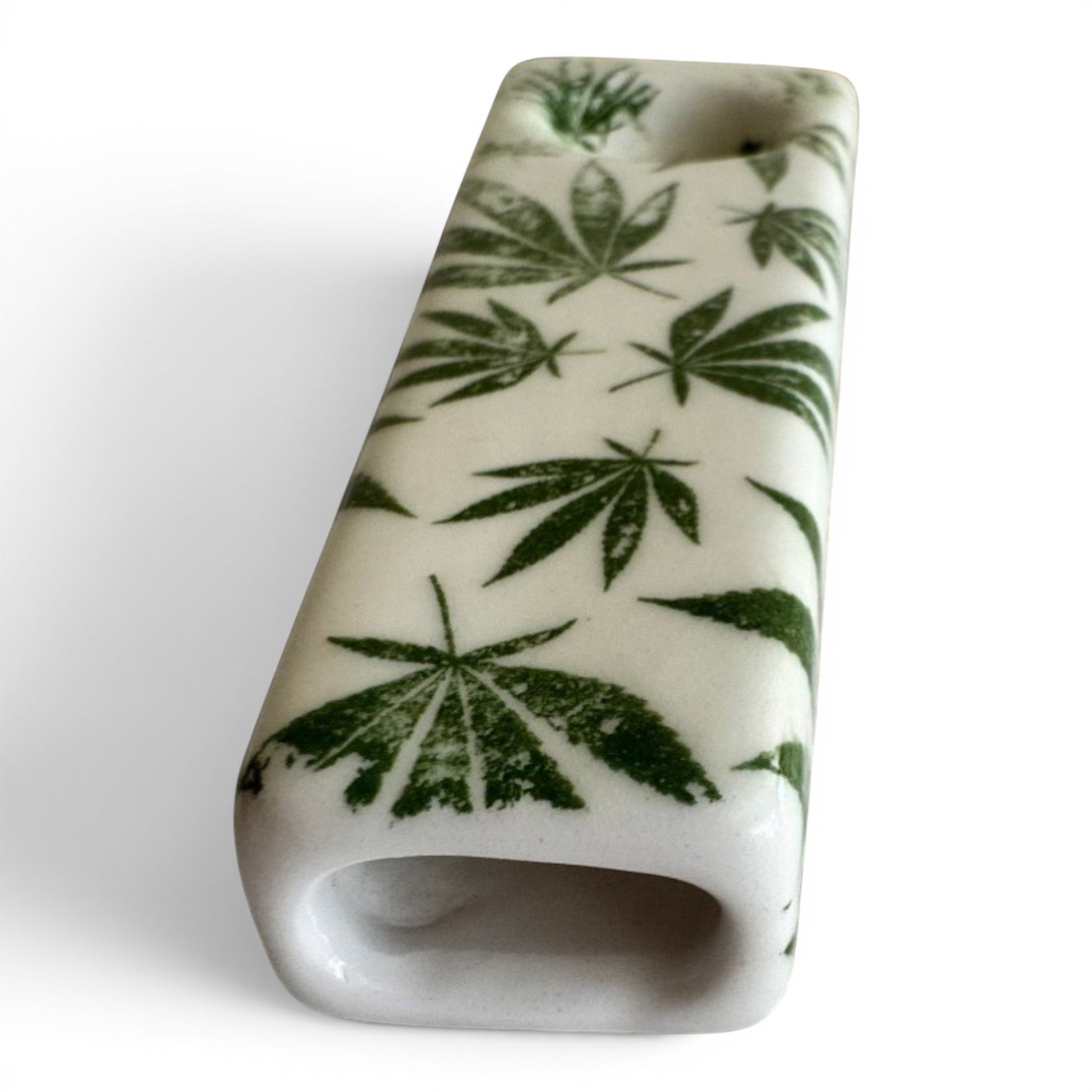 Rock N Art Shop hand-decorated stoneware tobacco pipe with green cannabis leaf design on white ceramic.