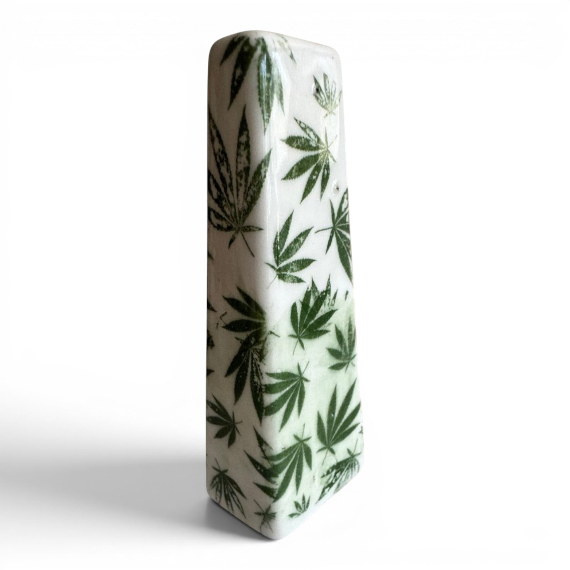 Rock N Art Shop hand-decorated stoneware tobacco pipe with green cannabis leaf design on white ceramic.