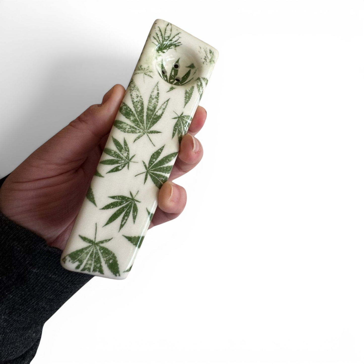 Rock N Art Shop hand-decorated stoneware tobacco pipe with green cannabis leaf design on white ceramic.