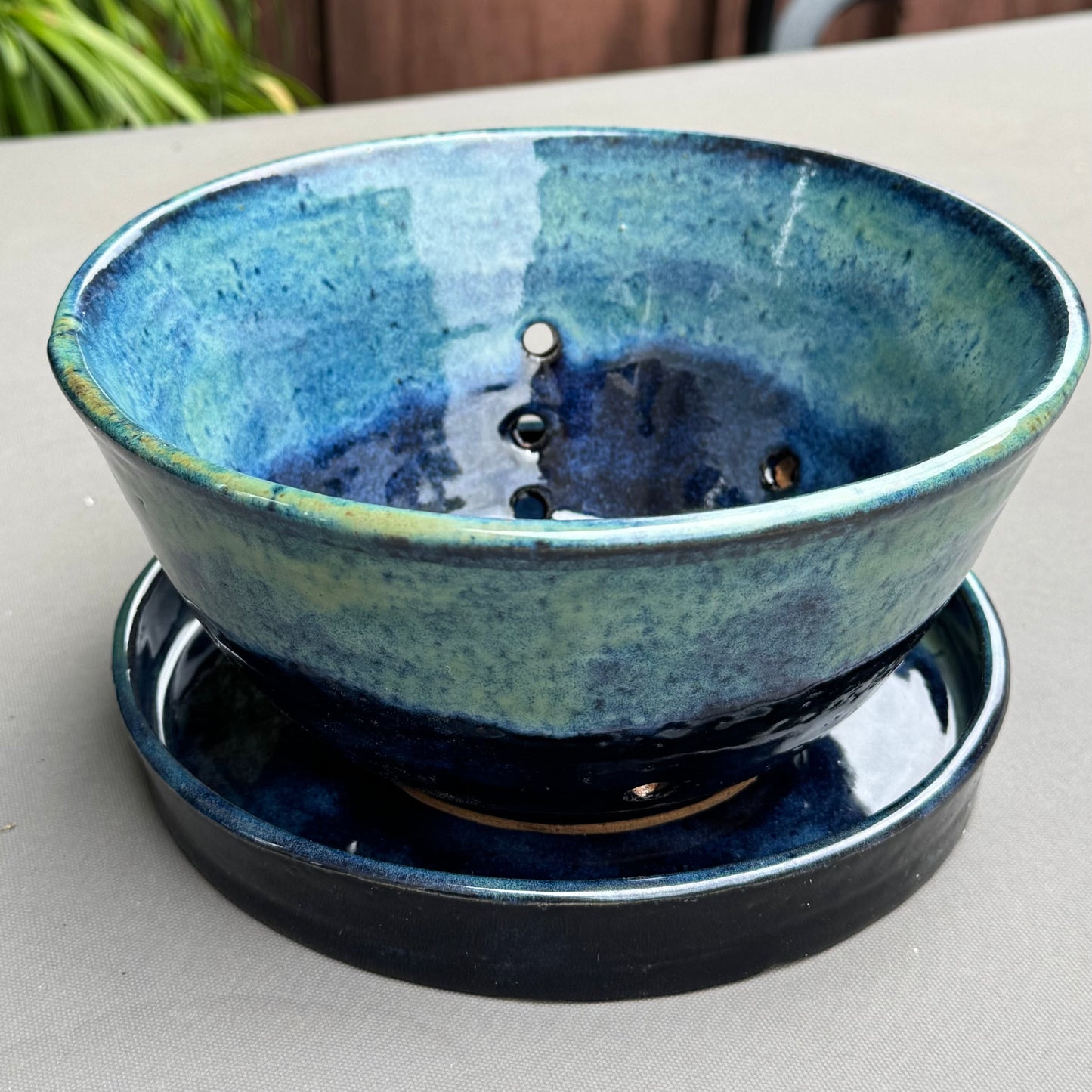 Rock N Art Shop handmade stoneware berry bowl and saucer with a blue and turquoise ocean-inspired glaze.