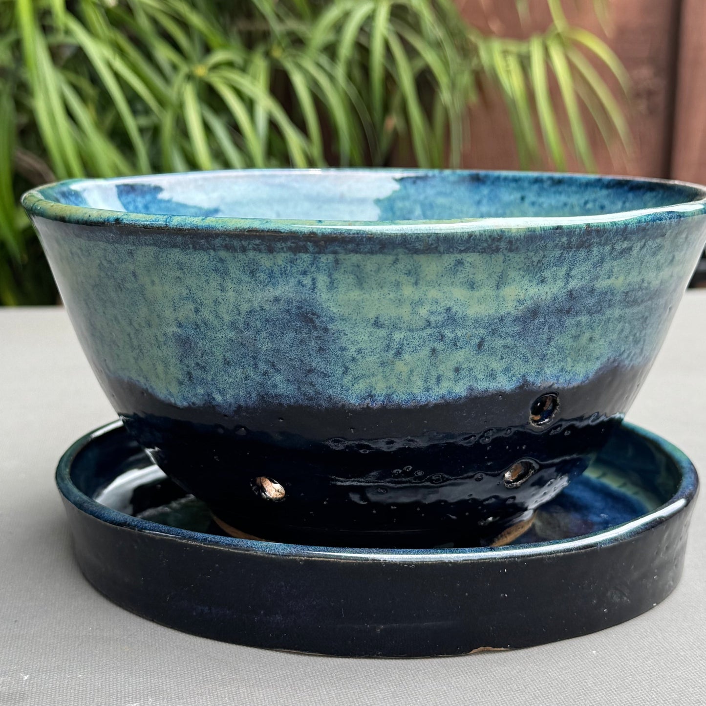 Rock N Art Shop handmade stoneware berry bowl and saucer with a blue and turquoise ocean-inspired glaze finish.