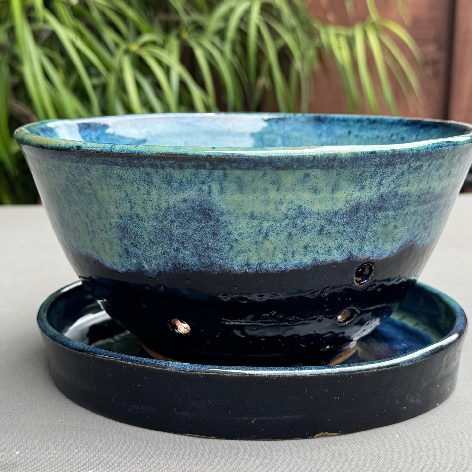 Rock N Art Shop handmade stoneware berry bowl and saucer with a blue and turquoise ocean-inspired glaze finish.