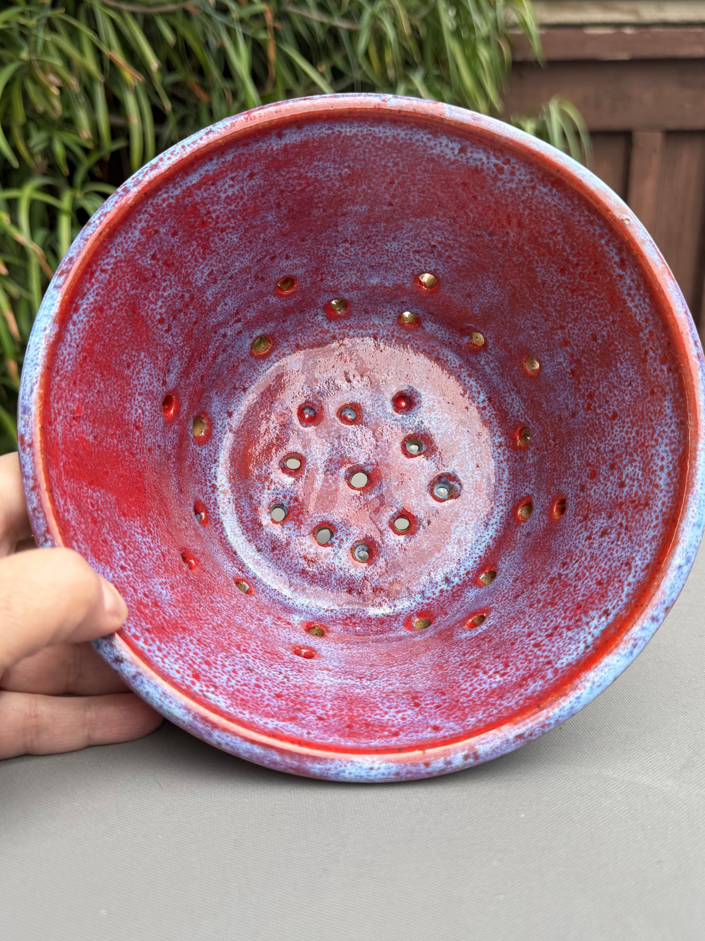 Rock N Art Shop handmade ceramic berry bowl with a vibrant ruby red interior and soft cloud-blue exterior glaze.