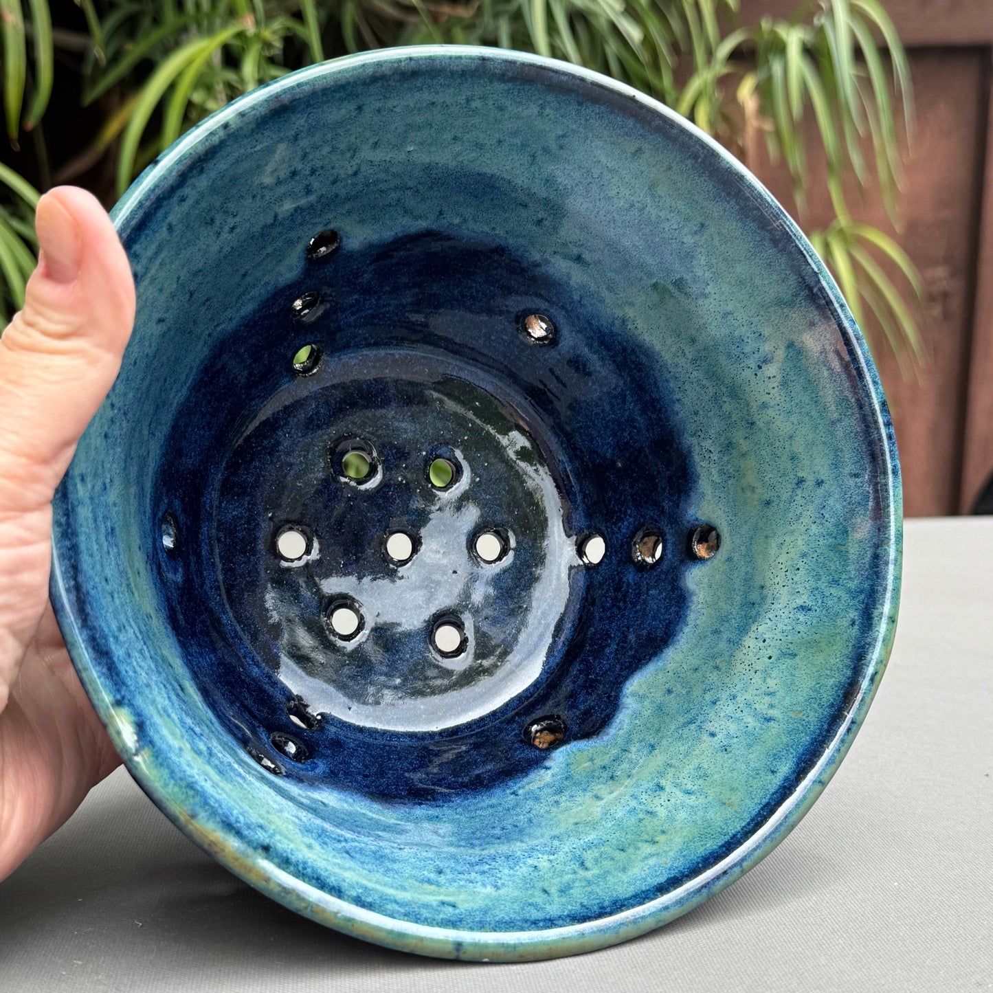 Rock N Art Shop handmade stoneware berry bowl with blue and turquoise glaze and drainage holes for rinsing fruit