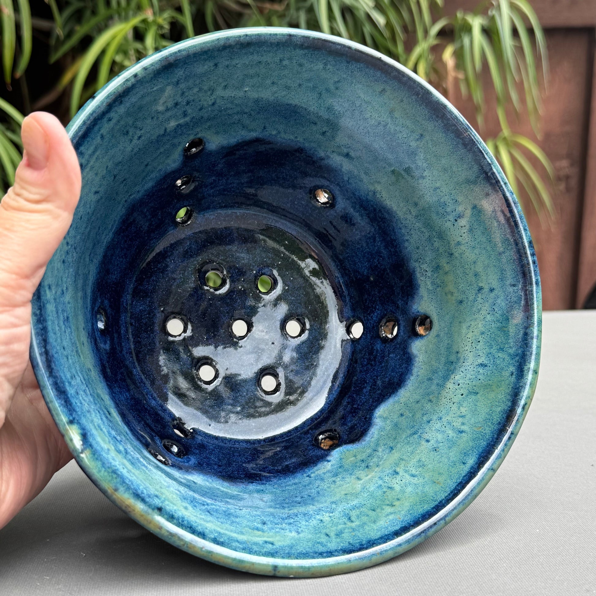 Rock N Art Shop handmade stoneware berry bowl with blue and turquoise glaze and drainage holes for rinsing fruit
