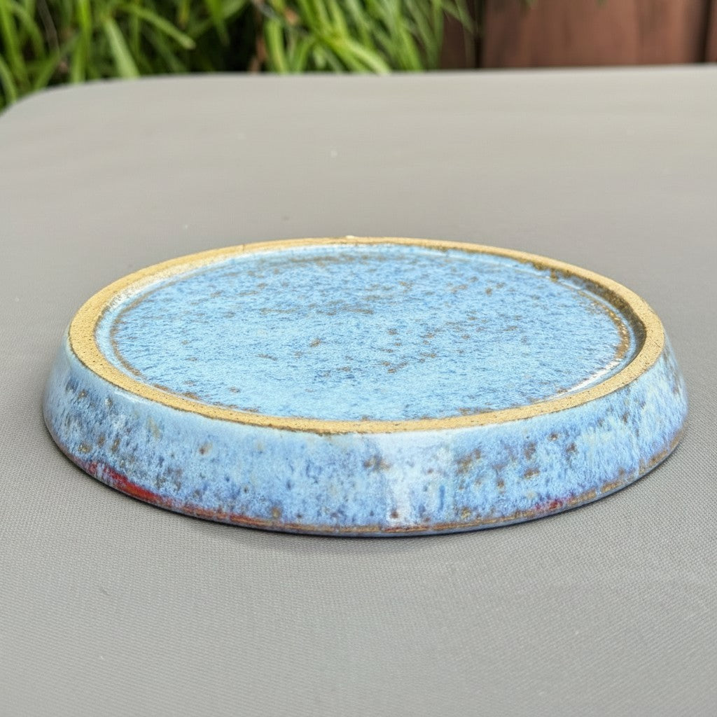 Rock N Art Shop handmade speckled stoneware saucer in cloud blue with a rustic rim for a ceramic berry bowl.