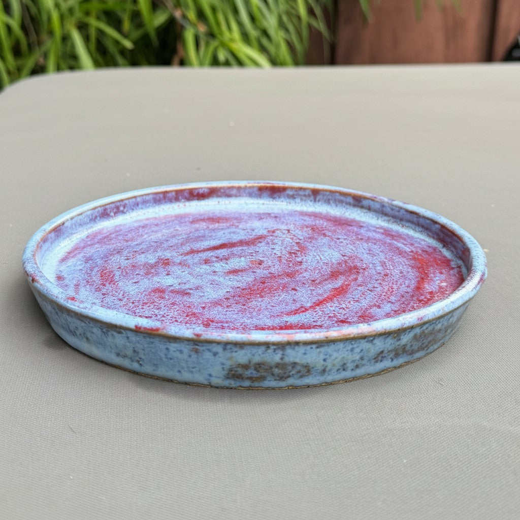 Rock N Art Shop handmade speckled stoneware saucer with a cloud-blue and ruby-red glazed finish.