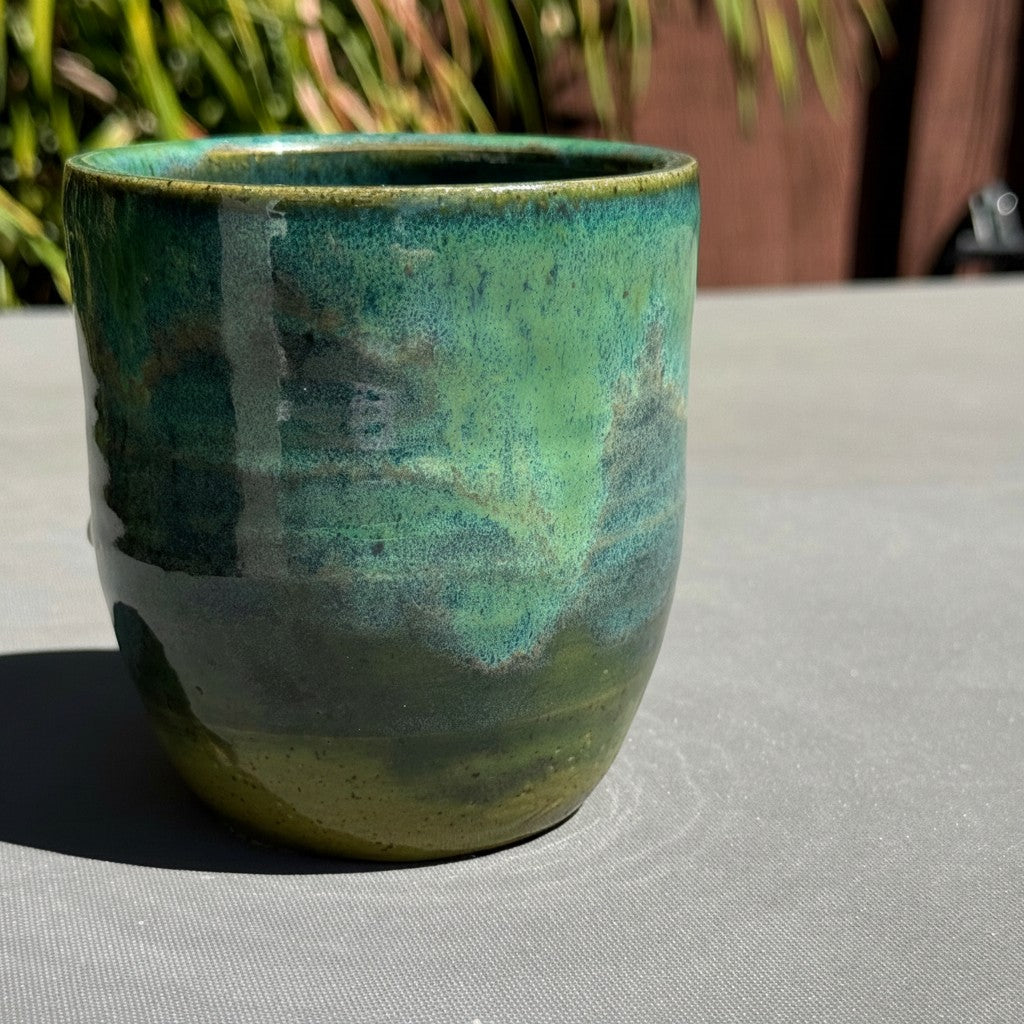 Rock N Art Shop handmade 16 oz stoneware tumbler in turquoise and green speckled glaze with a sculpted dragonfly