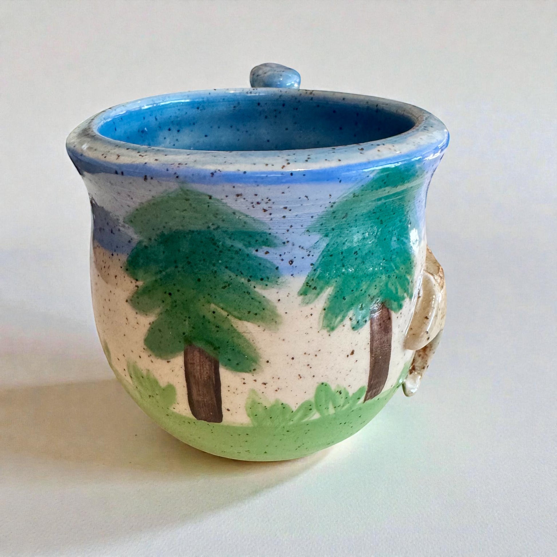 Rock N Art Shop Forest Bear stoneware mug with raised silhouette, hand-glazed in cabin tones of blue, green, and brown.