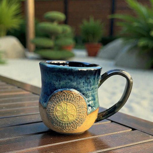 Rock N Art Shop handmade stoneware mug with ocean blue and seafoam green glaze, featuring a mandala relief appliqué. Approx. 15 oz.
