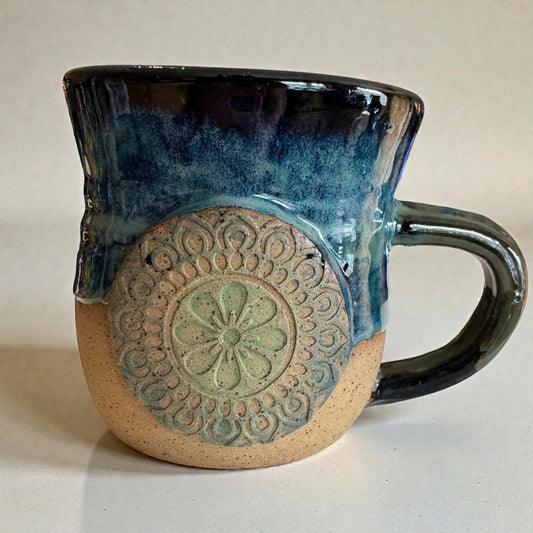 Rock N Art Shop handmade 15 oz stoneware mug with ocean blue and seafoam green glaze, featuring a mandala medallion appliqué.