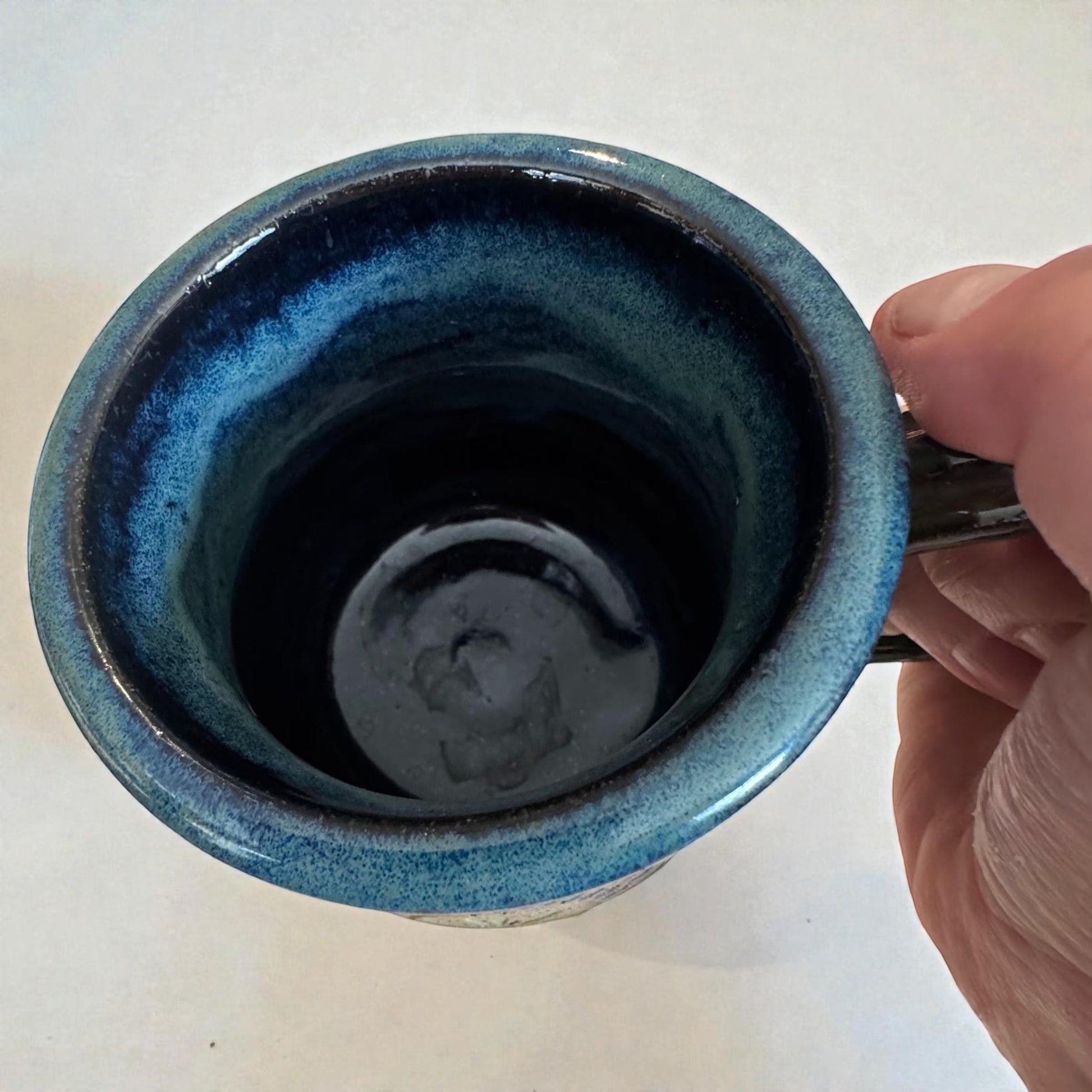 Rock N Art Shop handmade stoneware mug with ocean blue and seafoam green glaze, featuring a mandala relief appliqué. Approx. 15 oz.
