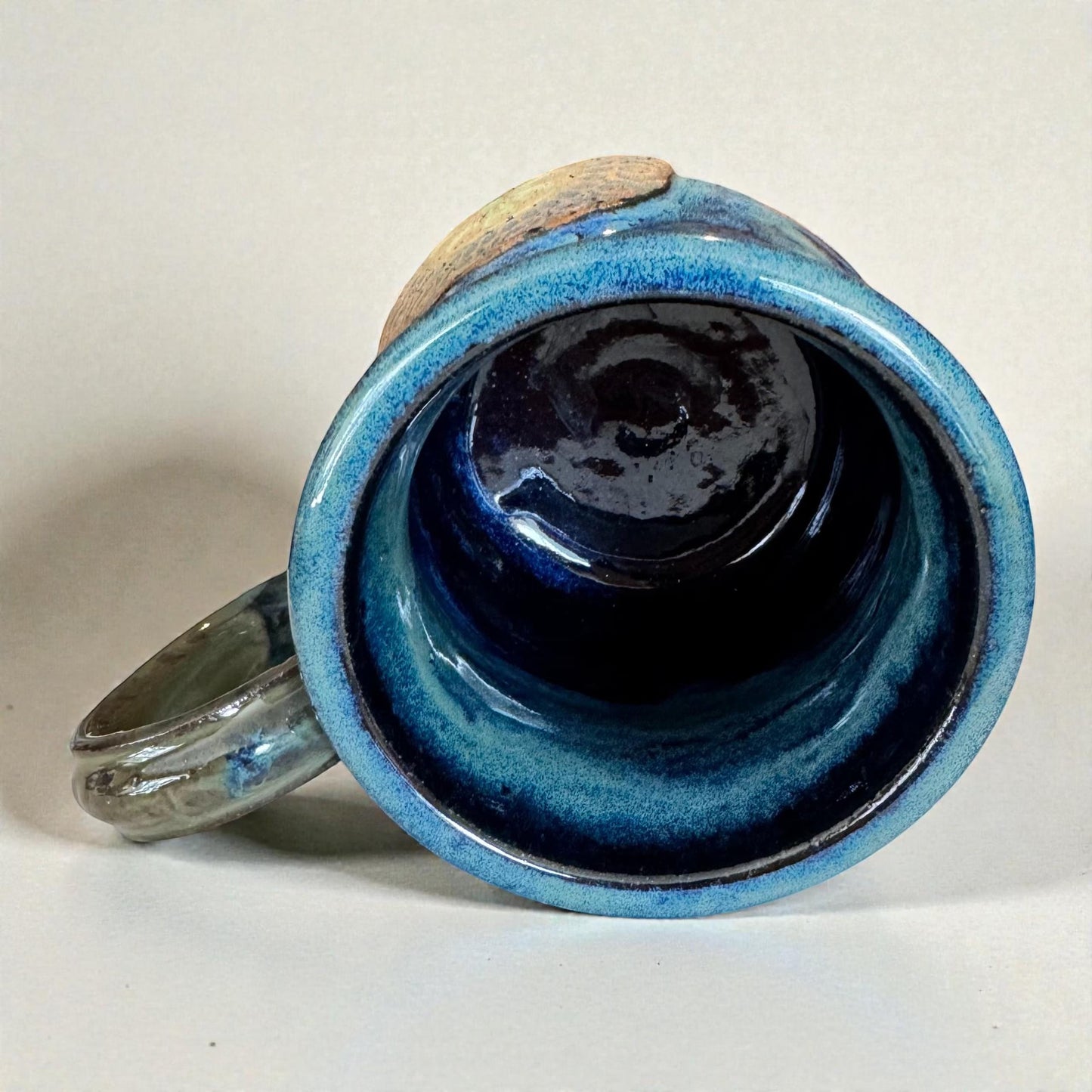 Rock N Art Shop handmade stoneware mug with ocean blue and seafoam green glaze, featuring a mandala relief. Approx. 15 oz capacity.