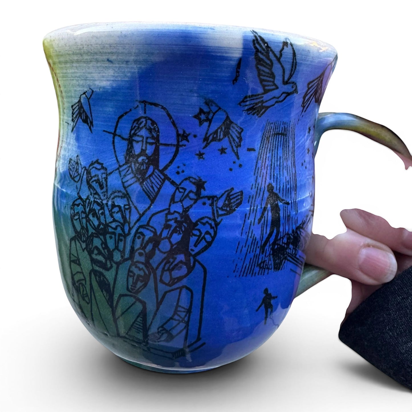 Rock N Art Shop handmade 12 oz ceramic mug with Rock N Roll Jesus artwork in blue and green glaze.