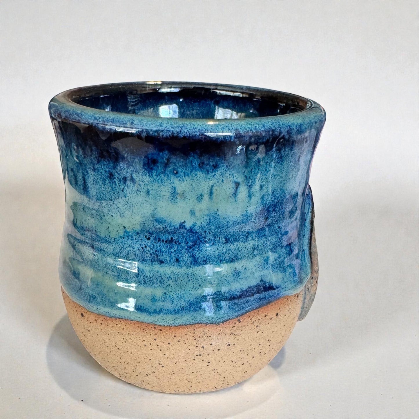 Rock N Art Shop handmade stoneware mug with ocean blue and seafoam green glaze, featuring a mandala relief. Approx. 15 oz capacity.