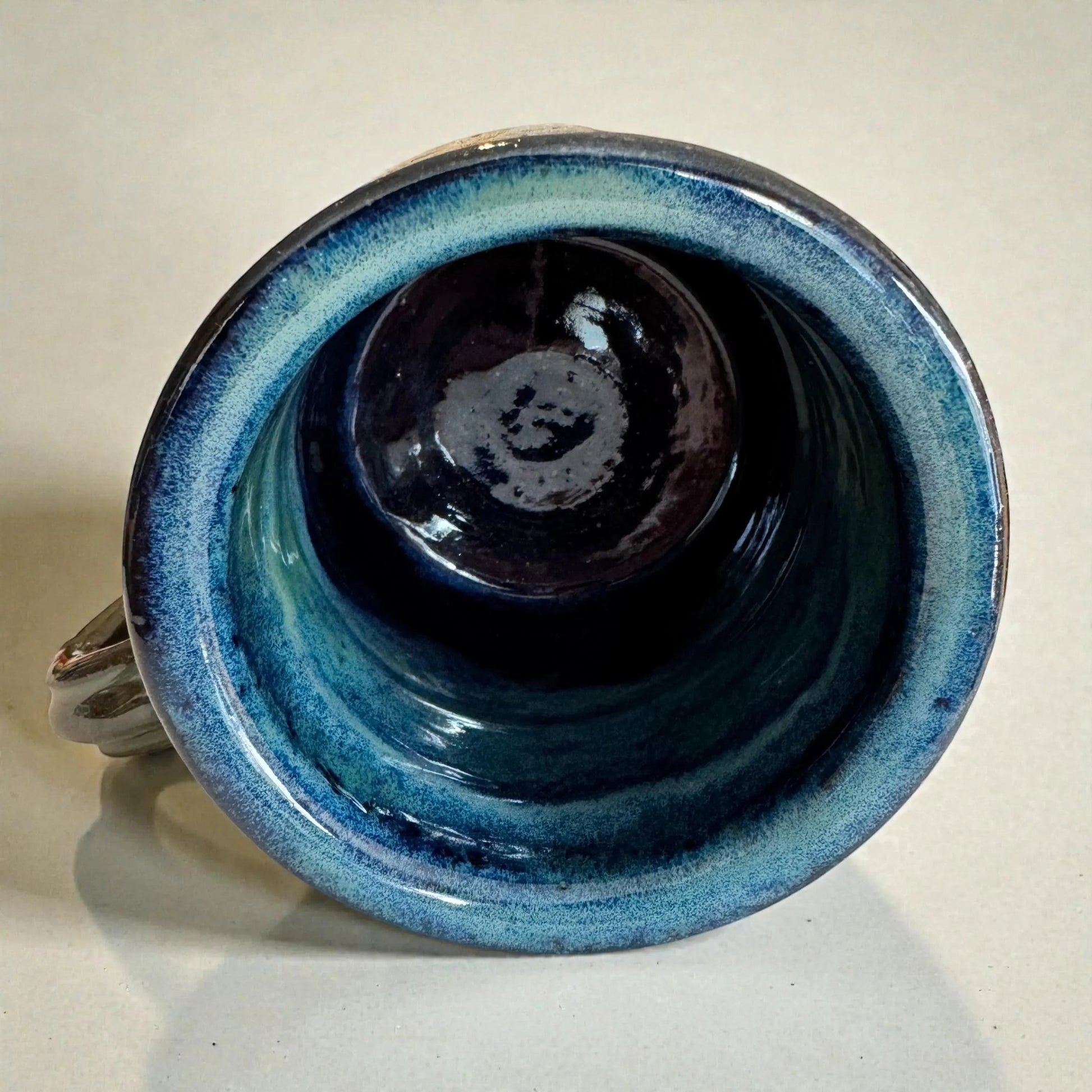 Rock N Art Shop handmade 15 oz stoneware mug with ocean blue and seafoam green glaze, featuring a mandala medallion.
