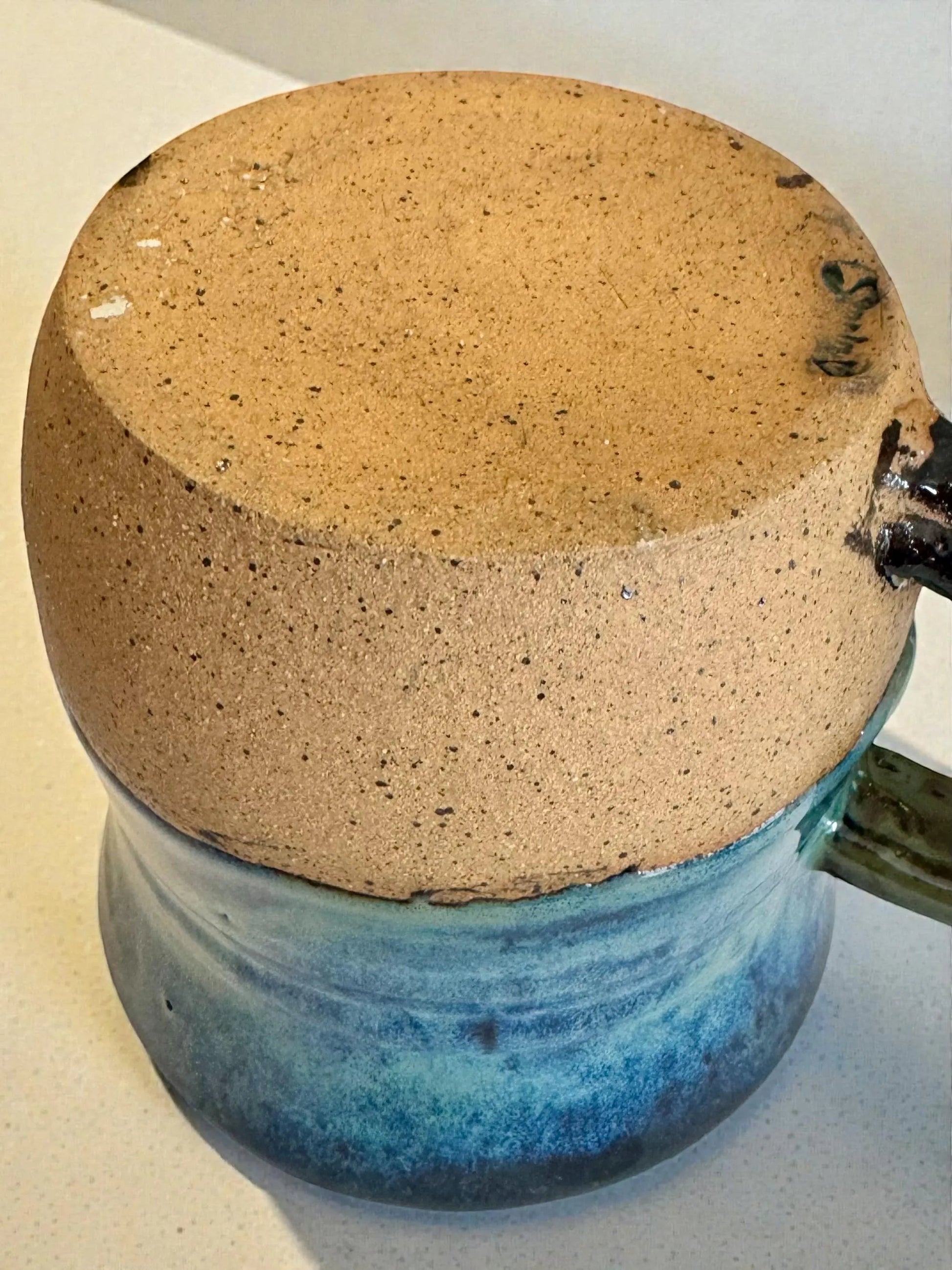 Rock N Art Shop handmade 15 oz stoneware mug with ocean blue and seafoam green glaze and mandala medallion detail.