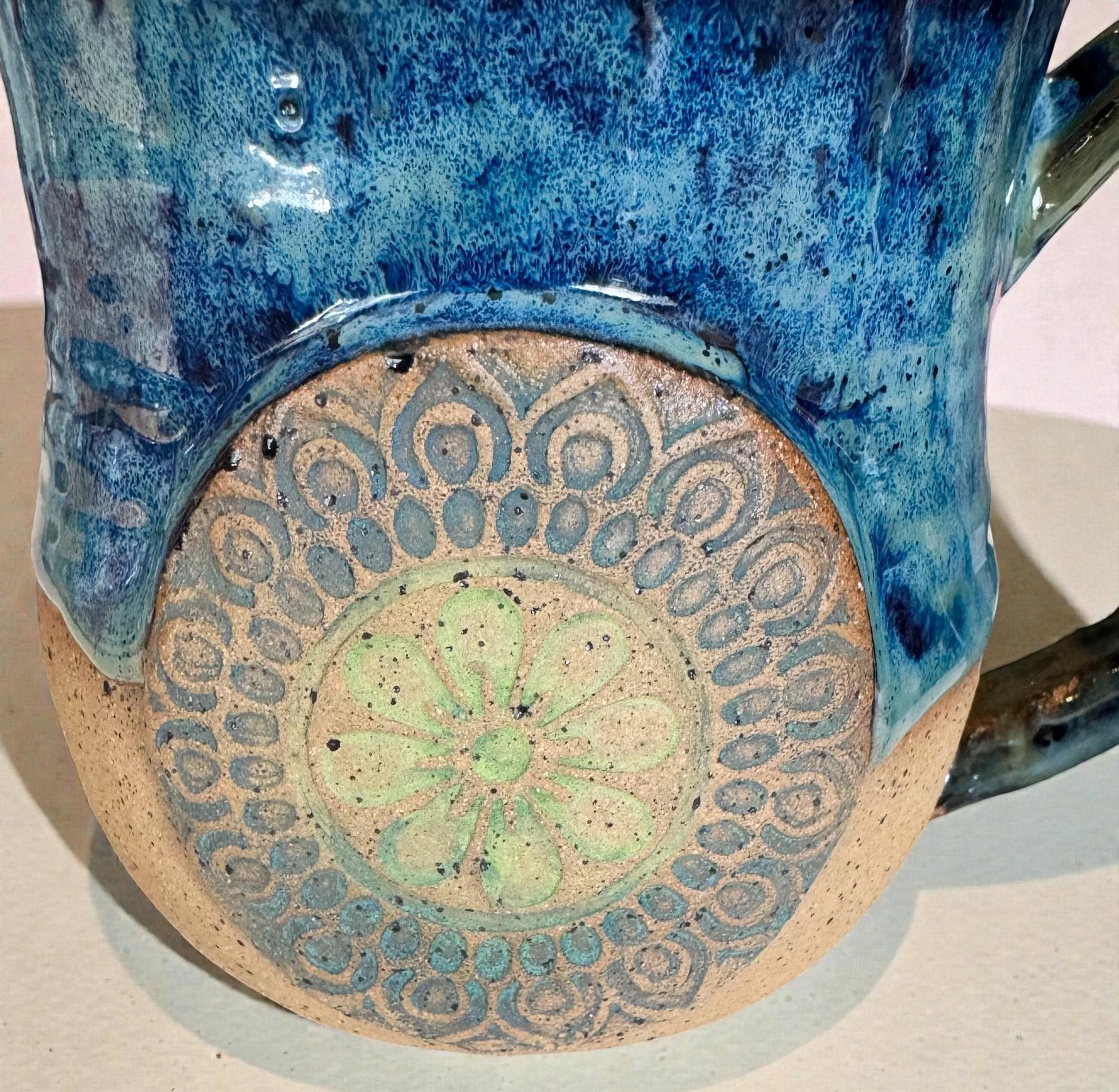 Rock N Art Shop handmade stoneware mug with ocean blue and seafoam green glaze, featuring a mandala relief appliqué.