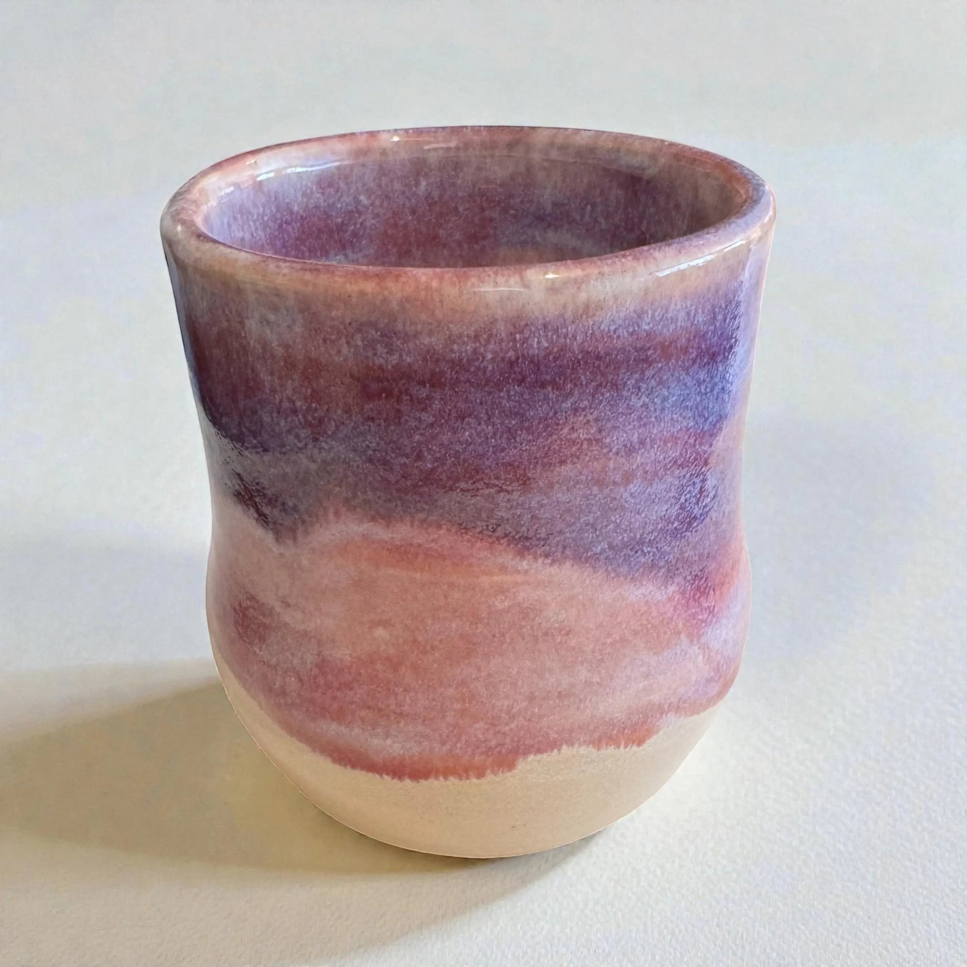 Rock N Art Shop 12 oz wheel-thrown stoneware mug with layered plum, mauve, and neutral tones. Handmade ceramic coffee mug.