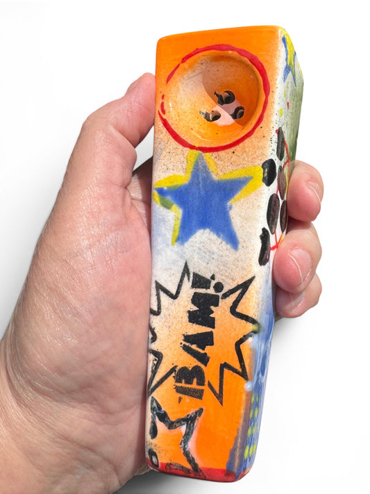 Rock N Art Shop Pop Art ceramic pipe with BAM! comic burst, blue star, and tangerine orange bowl.