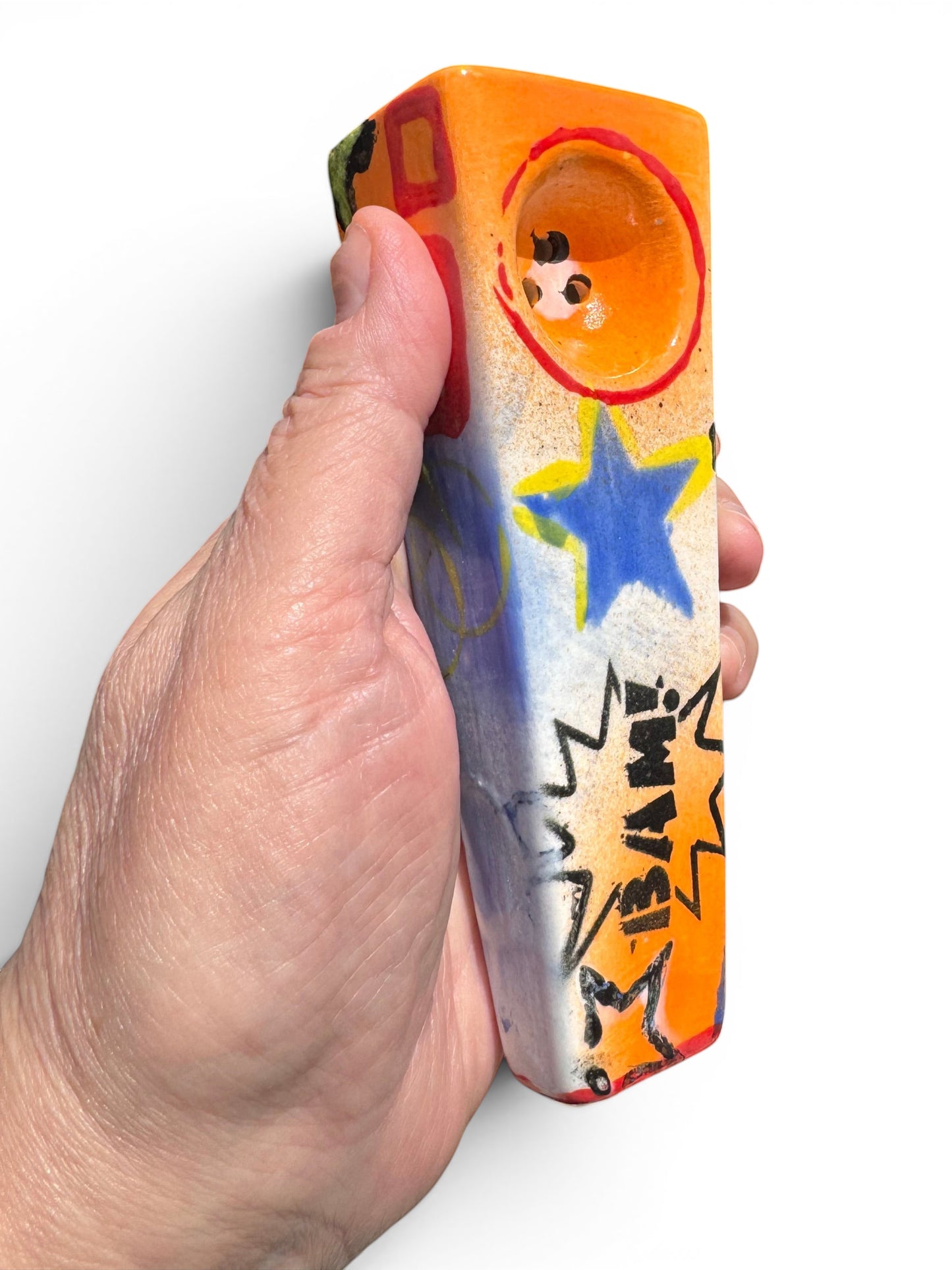 Rock N Art Shop hand-decorated ceramic tobacco pipe with BAM! comic burst, cobalt star, and tangerine orange bowl.