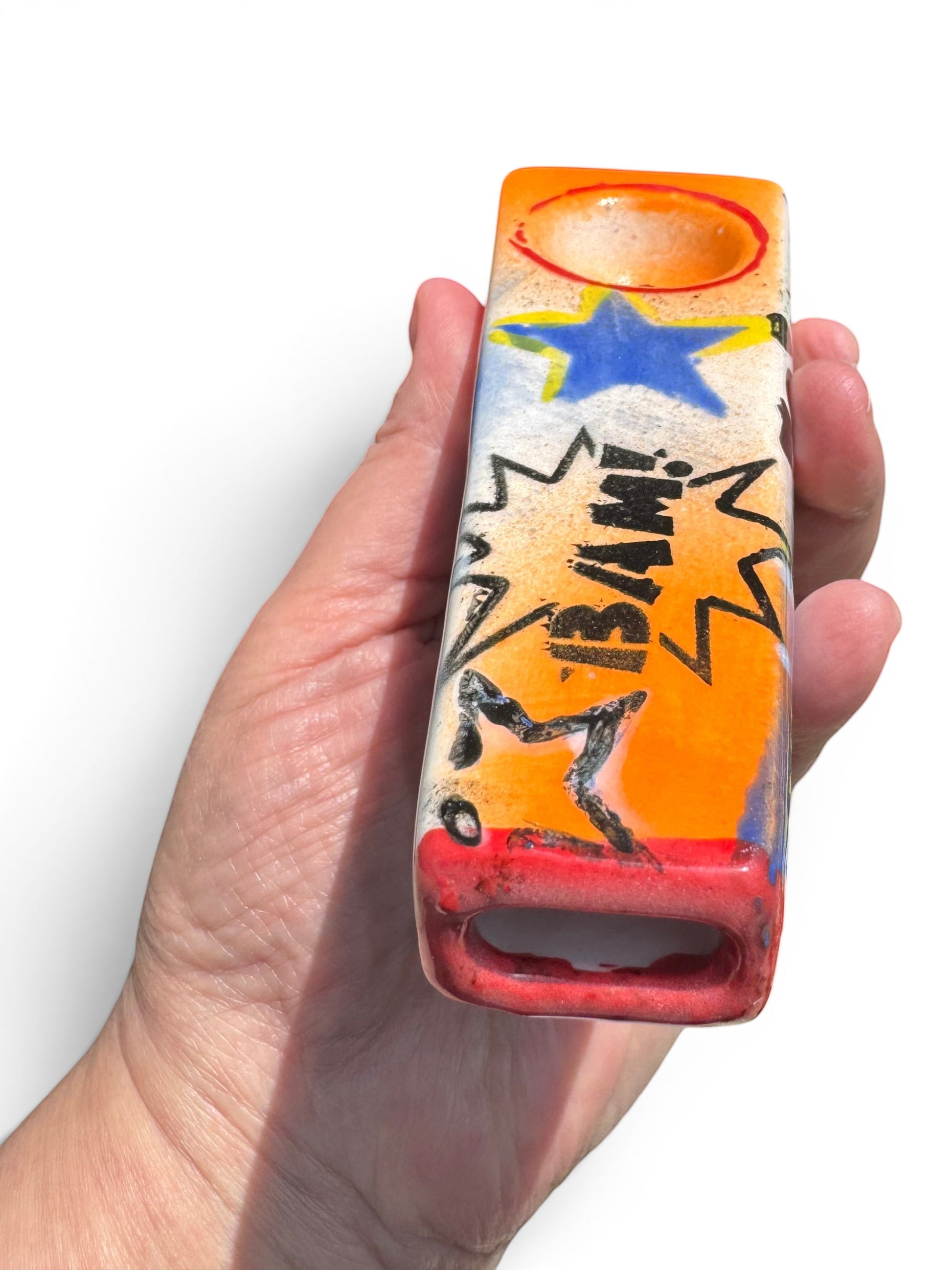 Rock N Art Shop hand-decorated ceramic tobacco pipe with BAM! comic burst, blue star, and orange bowl.