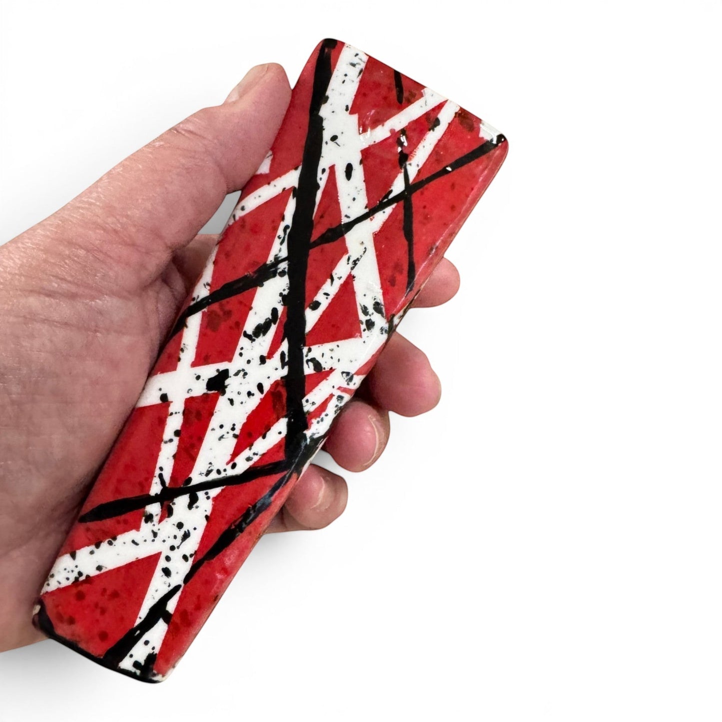 Rock N Art Shop hand-decorated stoneware tobacco pipe with red, black, and white diagonal stripe design and black splatter accents.