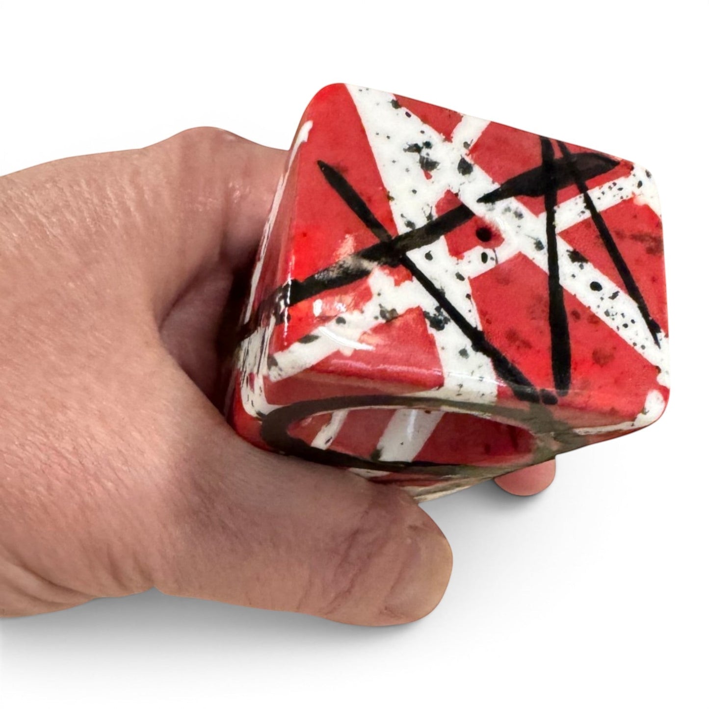 Rock N Art Shop hand-decorated stoneware tobacco pipe with red, black, and white diagonal stripe design and black splatter accents.