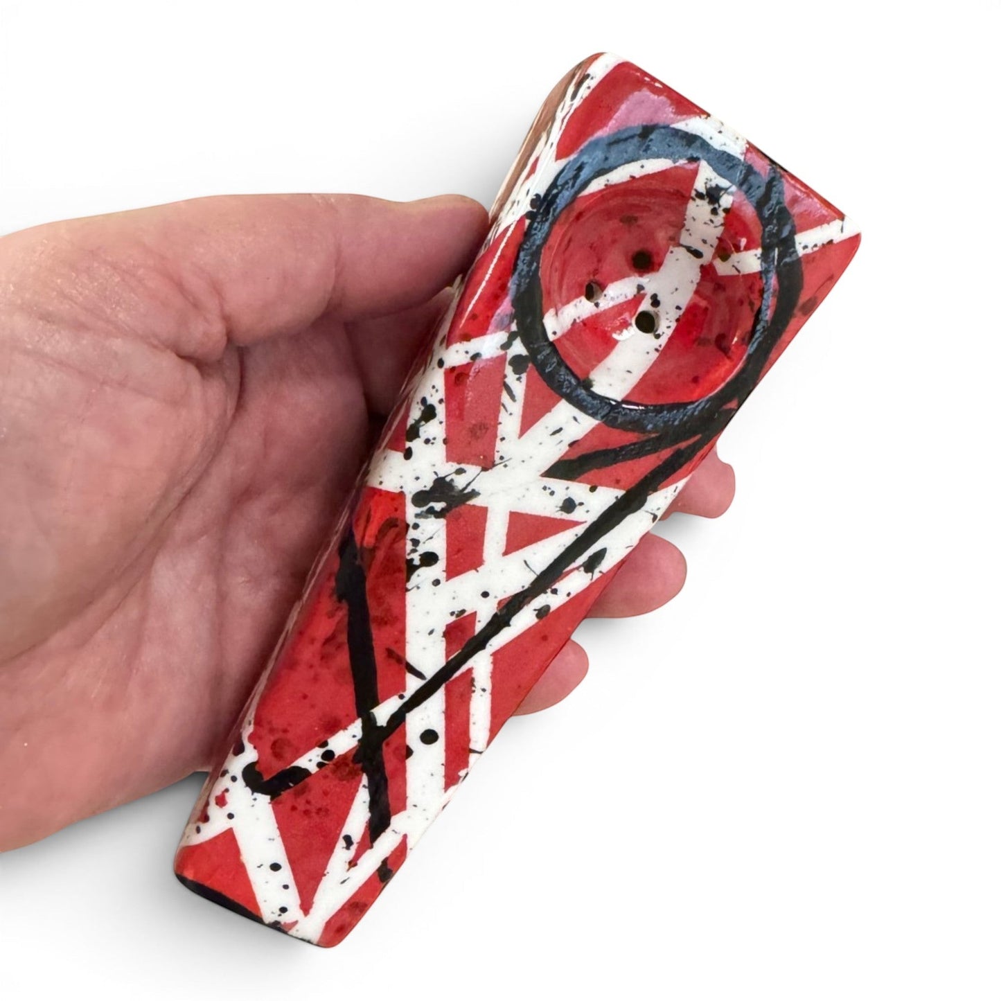 Rock N Art Shop hand-decorated stoneware tobacco pipe with red, black, and white diagonal stripe design and black splatter accents.