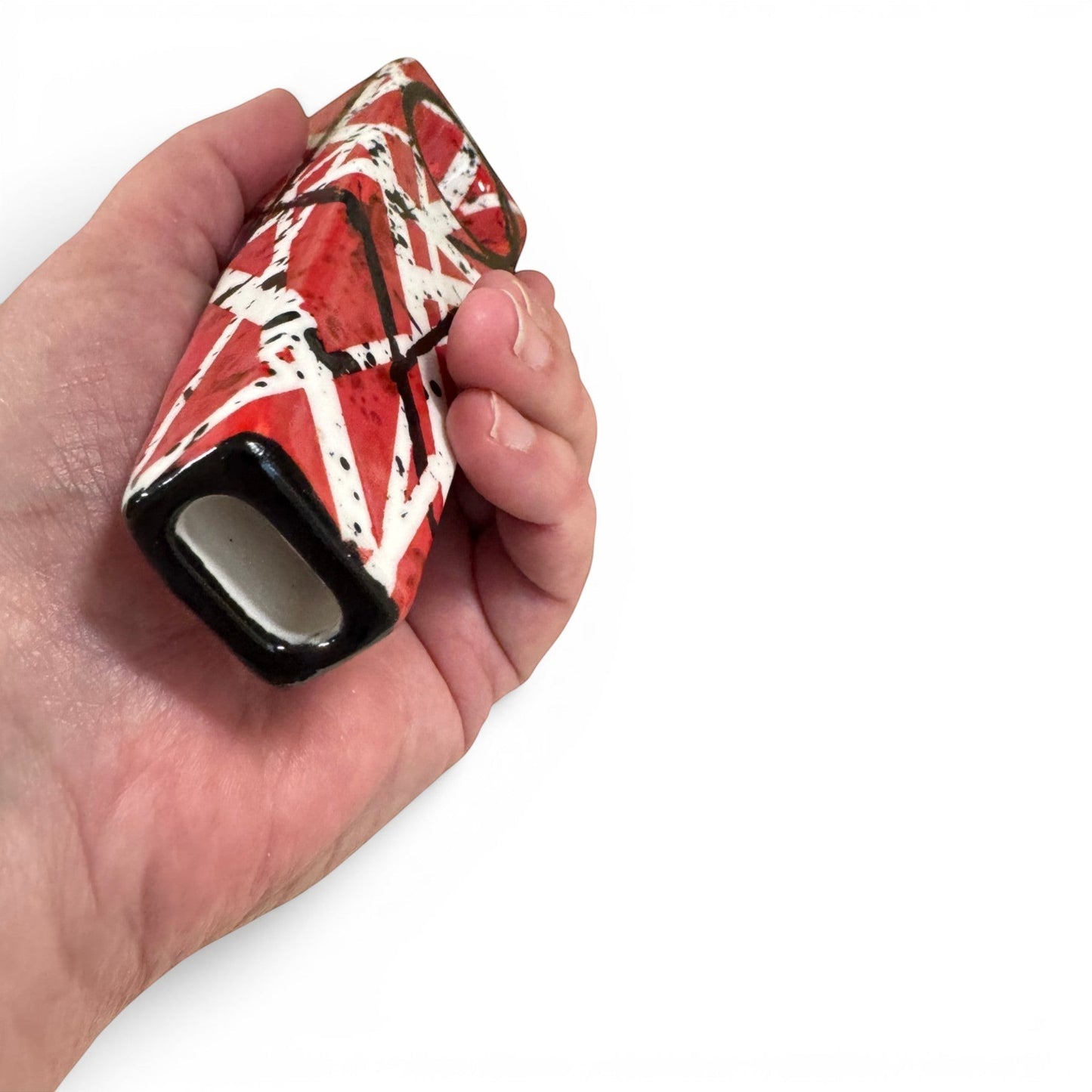 Rock N Art Shop hand-decorated stoneware tobacco pipe with red, black, and white diagonal stripe design and black splatter accents.