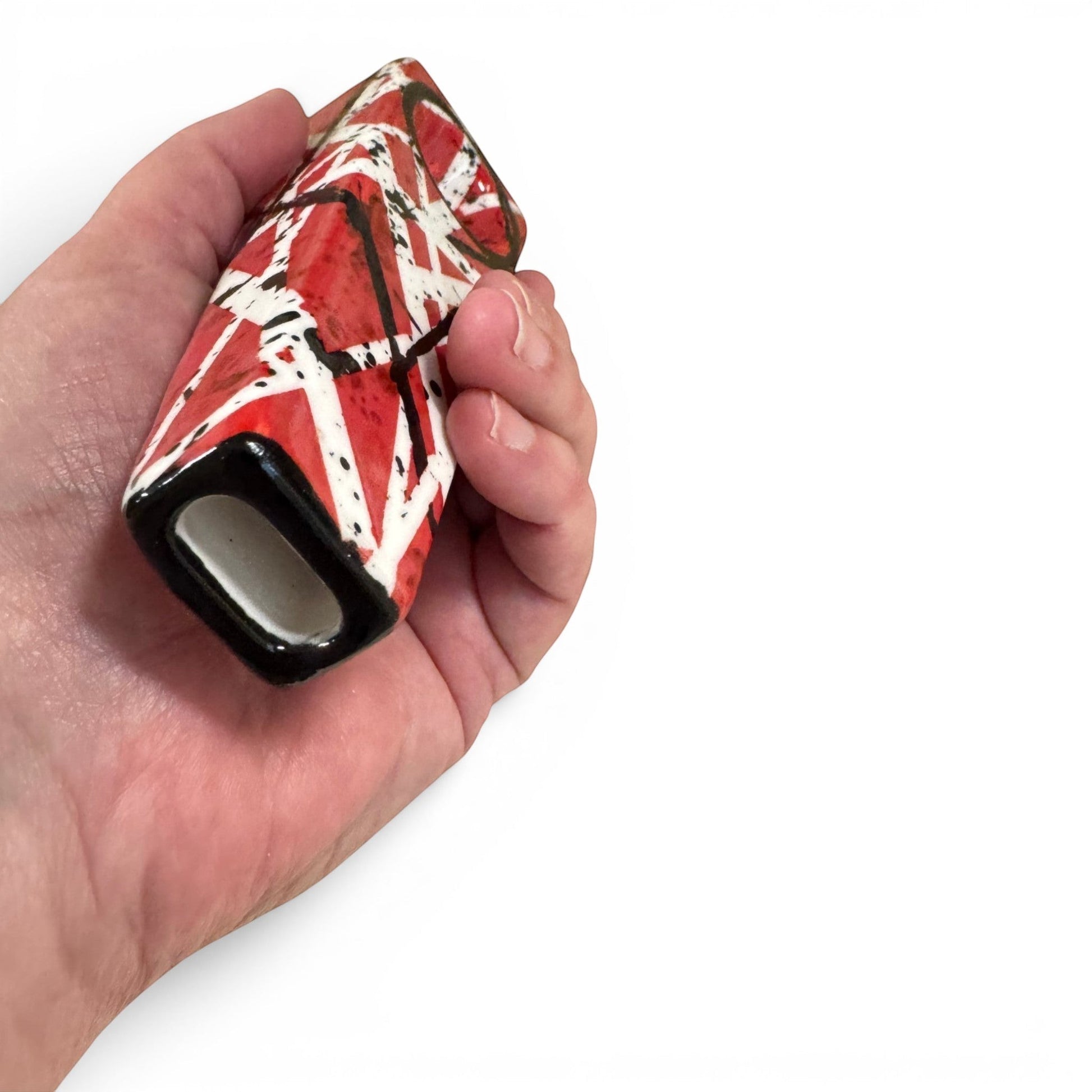 Rock N Art Shop hand-decorated stoneware tobacco pipe with red, black, and white diagonal stripe design and black splatter accents.