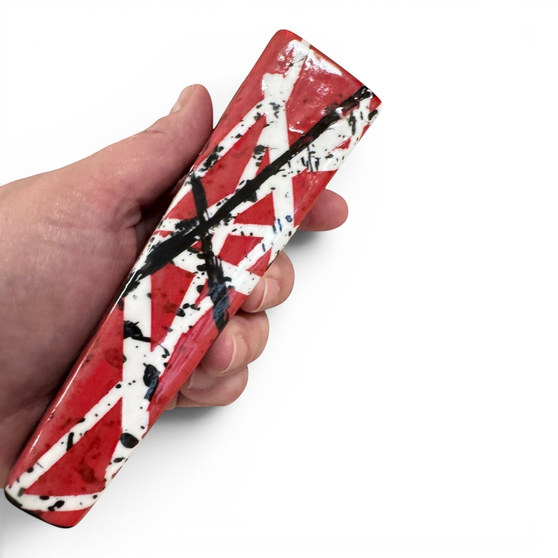 Rock N Art Shop hand-decorated stoneware tobacco pipe with red, black, and white diagonal stripe design and black splatter accents.