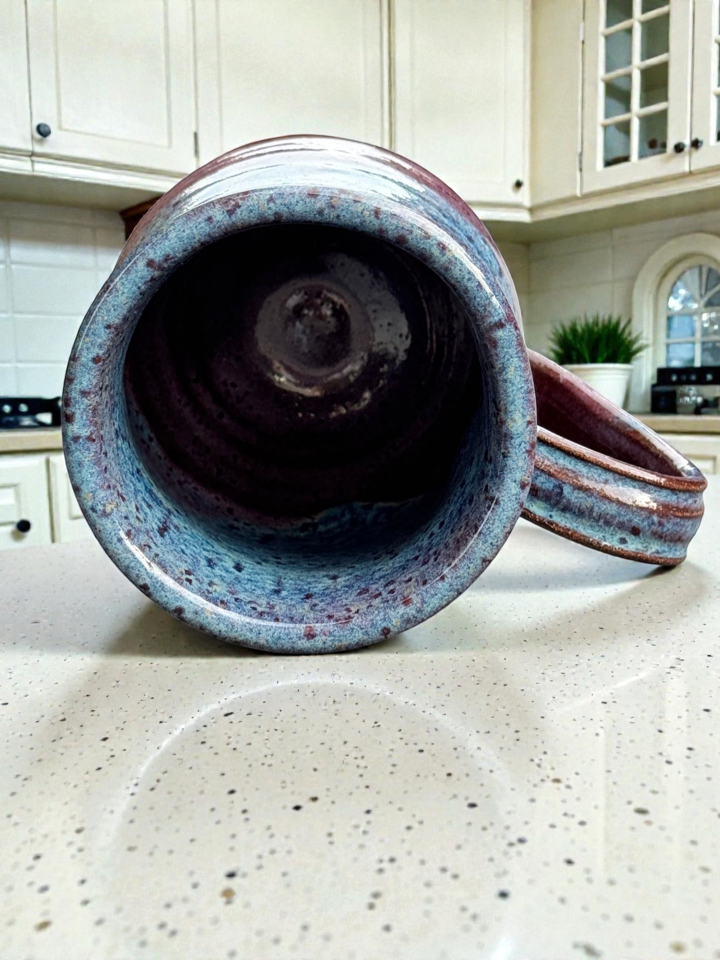 Rock N Art Shop handmade 14 oz speckled blue and plum stoneware mug. Wheel thrown pottery with rustic artisan finish.