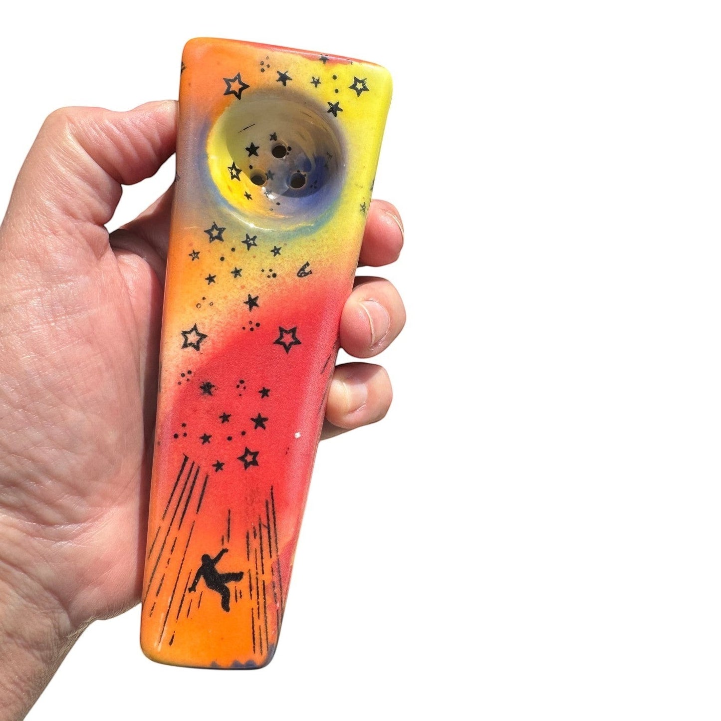 Rock N Art Shop hand-decorated ceramic pipe with cosmic star design, featuring a falling figure and UFO. Approx. 5" long.